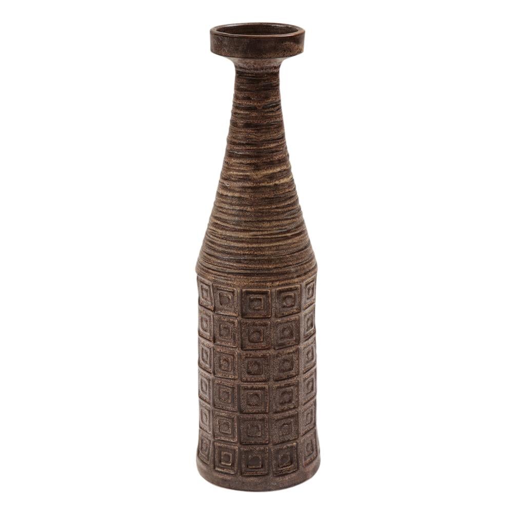 Bitossi for Raymor vase, ceramic, earth tones, geometric, signed. Tall bottle form vase with a flared rim and decorated with patterns of incised ridges and impressed squares. Signed on underside: 402 A Italy. A faint outline of a Raymor label can