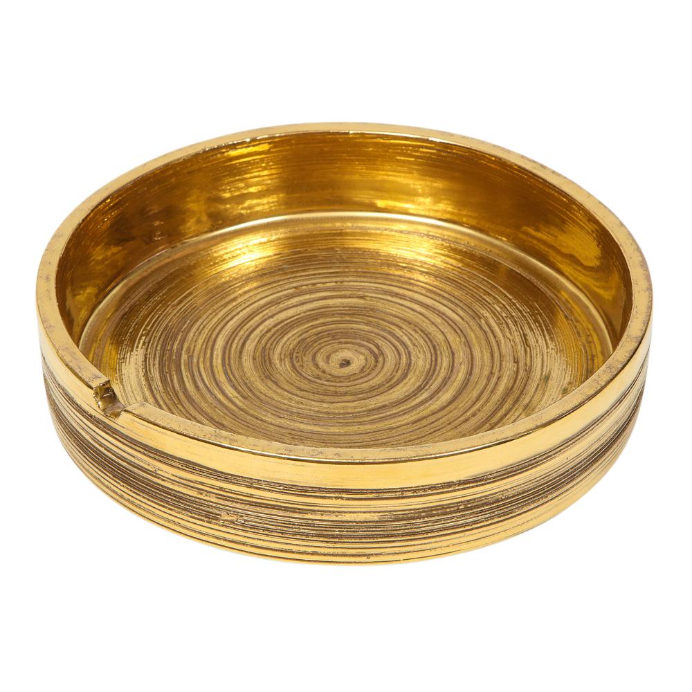 Bitossi for Berkeley House ashtray, brushed gold, signed. Medium scale textured ashtray with one cigarette rest. The Bitossi factory mixed 24-karat gold to achieve the luster in their gold glazes. Retains original paper label on the underside which
