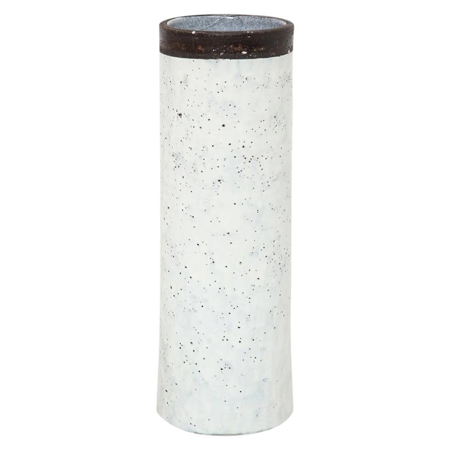 Bitossi for Raymor vase, ceramic, white and brown, signed. Tall cylinder vase with white glazed body and coarse matte brown clay collar. Signed on the underside FF 32. Retains Raymor paper label which reads: BIT 3744 C. Minor glaze skip on bottom