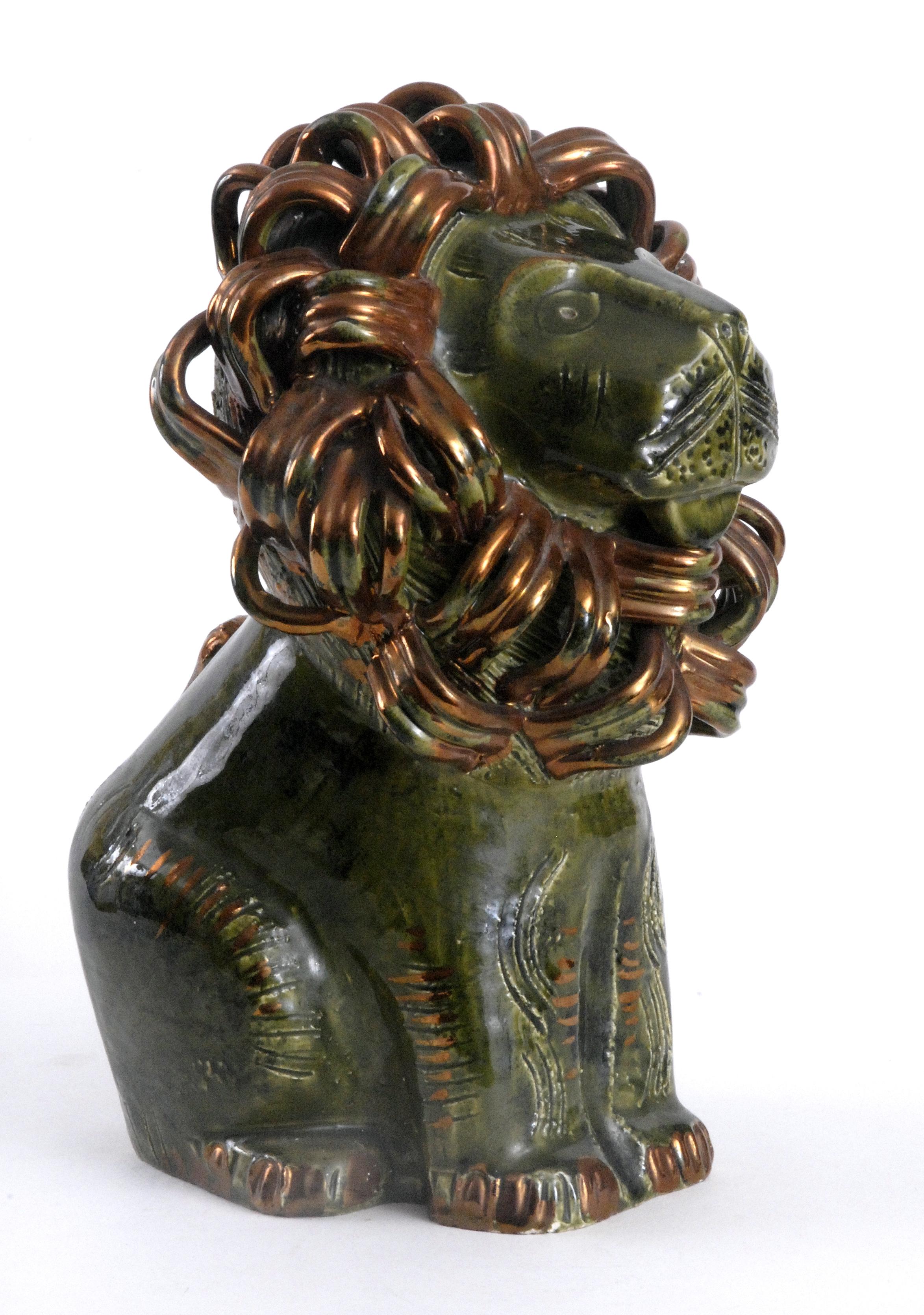 A magnificent large sitting green and gold lion with an intricately detailed mane in a copper/gold glaze. This would make a wonderful centre-piece for any collection of Italian ceramics. With original paper label to the underside.