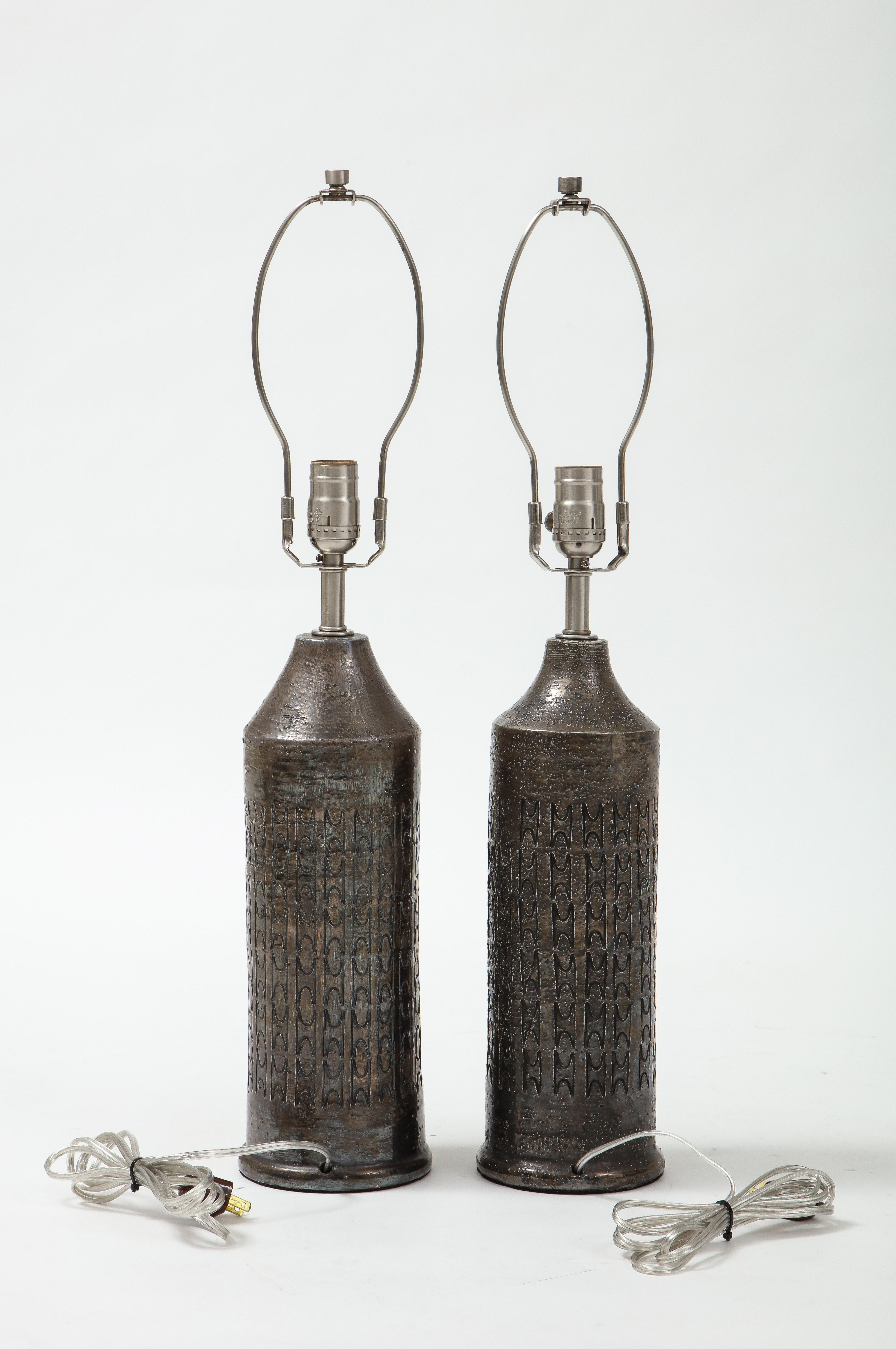 Pair of Italian hand built ceramic lamps with a sophisticated gunmetal glaze and hand inscribed chain pattern. Rewired for use in the USA, 100W max. Height listed is an overall height including harp.
