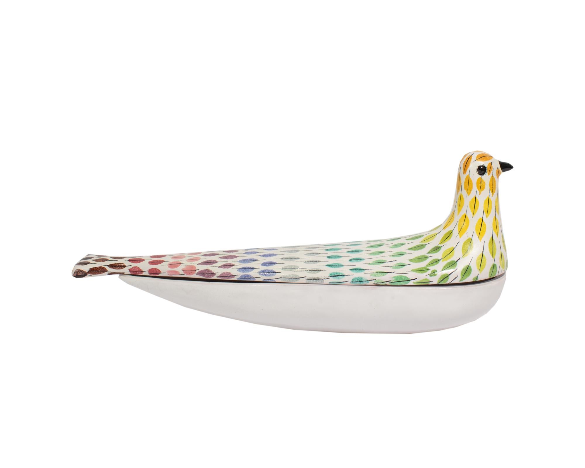 A box in the Piume pattern produced by Bitossi. Made in Italy, this box is in the shape of a bird with a rainbow feather design throughout. The lower part of the box is teardrop-shaped and is solid white. The underside of the box is marked 