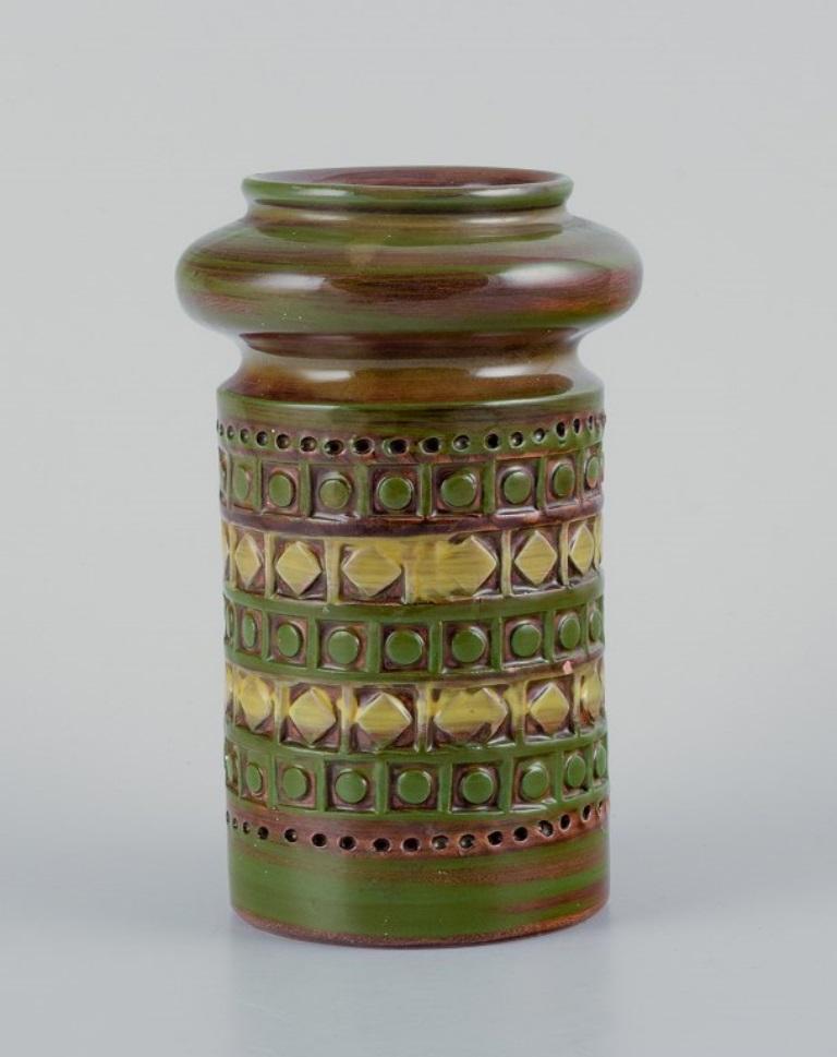 Bitossi, Italy, ceramic vase with geometric pattern and glaze in green, brown, and yellow tones.
1960s/1970s.
In excellent condition, with minimal and insignificant chip at the top.
Stamped.
Dimensions: H 14.2 x D 7.5 cm.