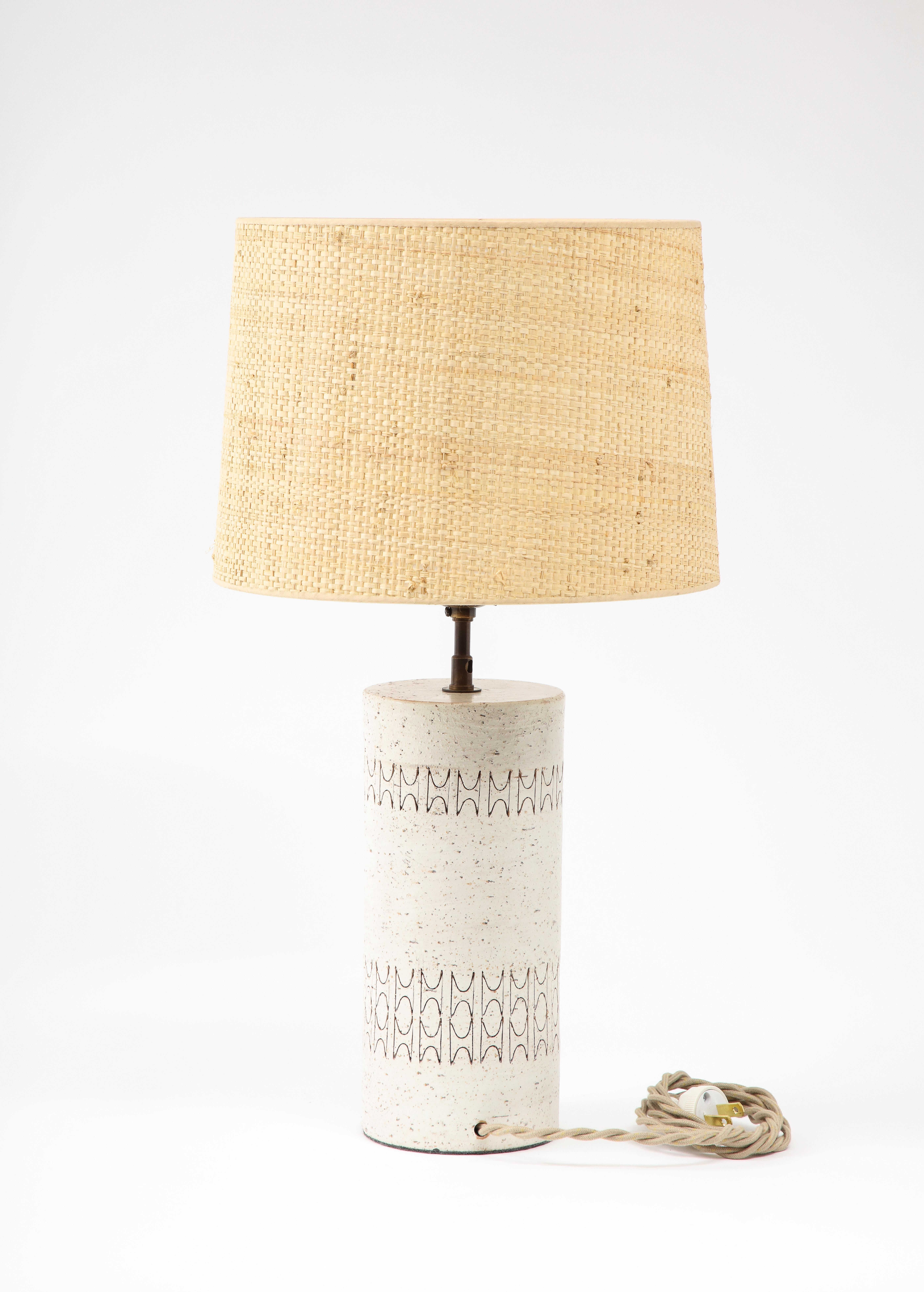Incised ceramic table lamp by Bitossi, the lamp is rewired with a keyed socket and silk cord with a period-styled plug. No shade included.