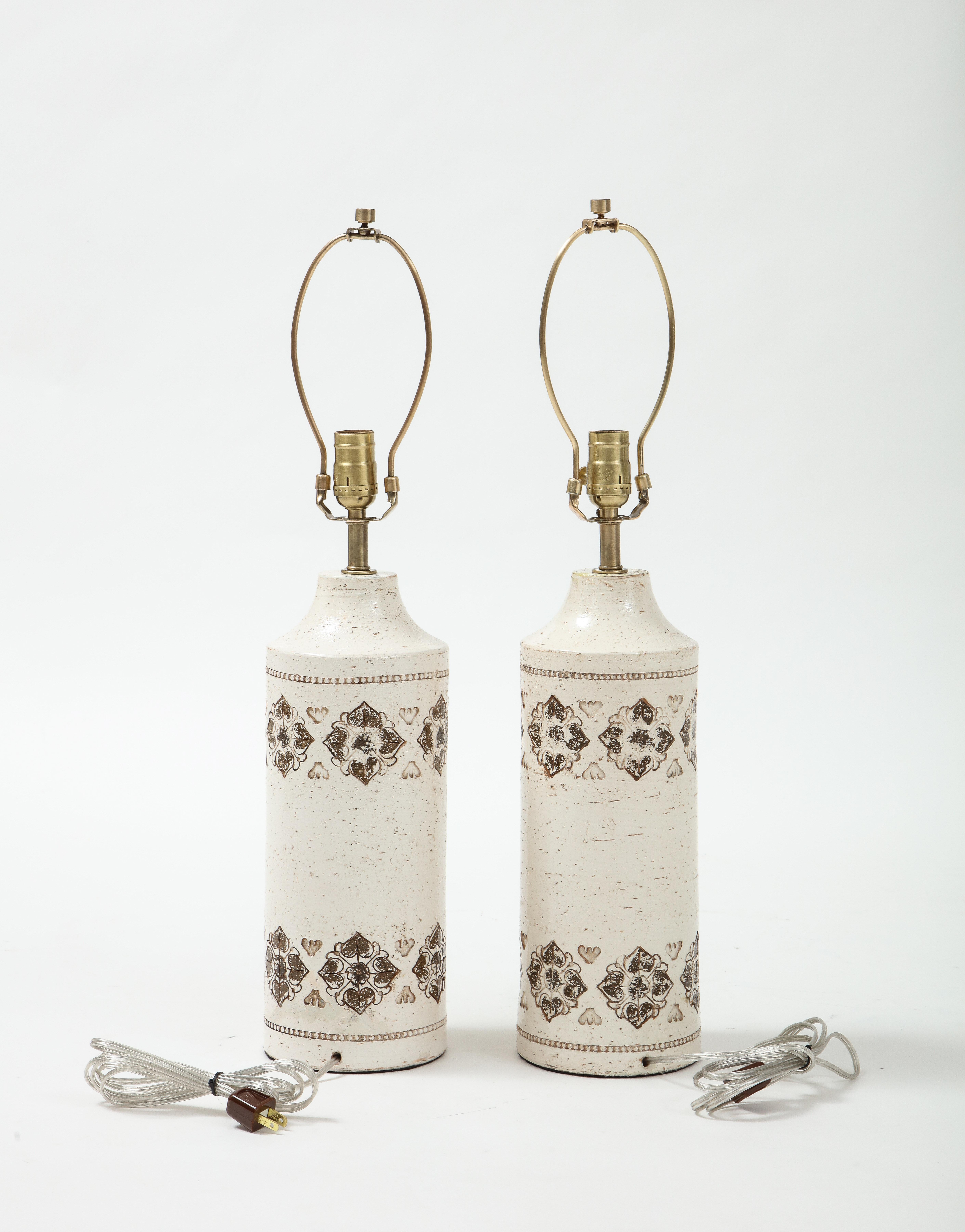 Pair of Italian ceramic lamps with an all over birch tree glaze with hand decorated stampato borders. Rewired for use in the USA. 100W max. Height listed is an overall height with harp.