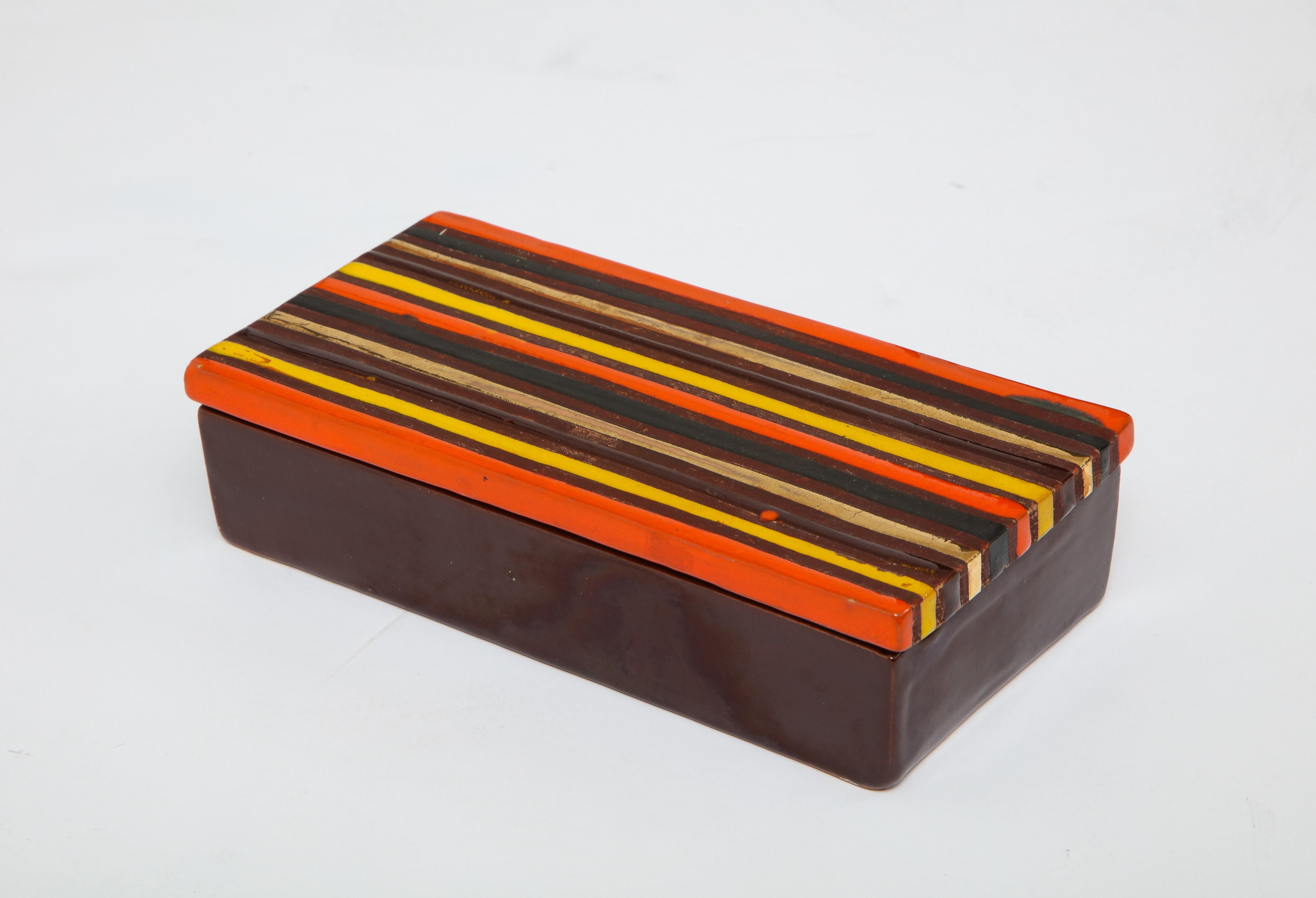 Bitossi brown glazed ceramic keepsake box with a contrasting striped ceramic top. Top features orange, yellow, brown and gold metallic glazes. Signed.