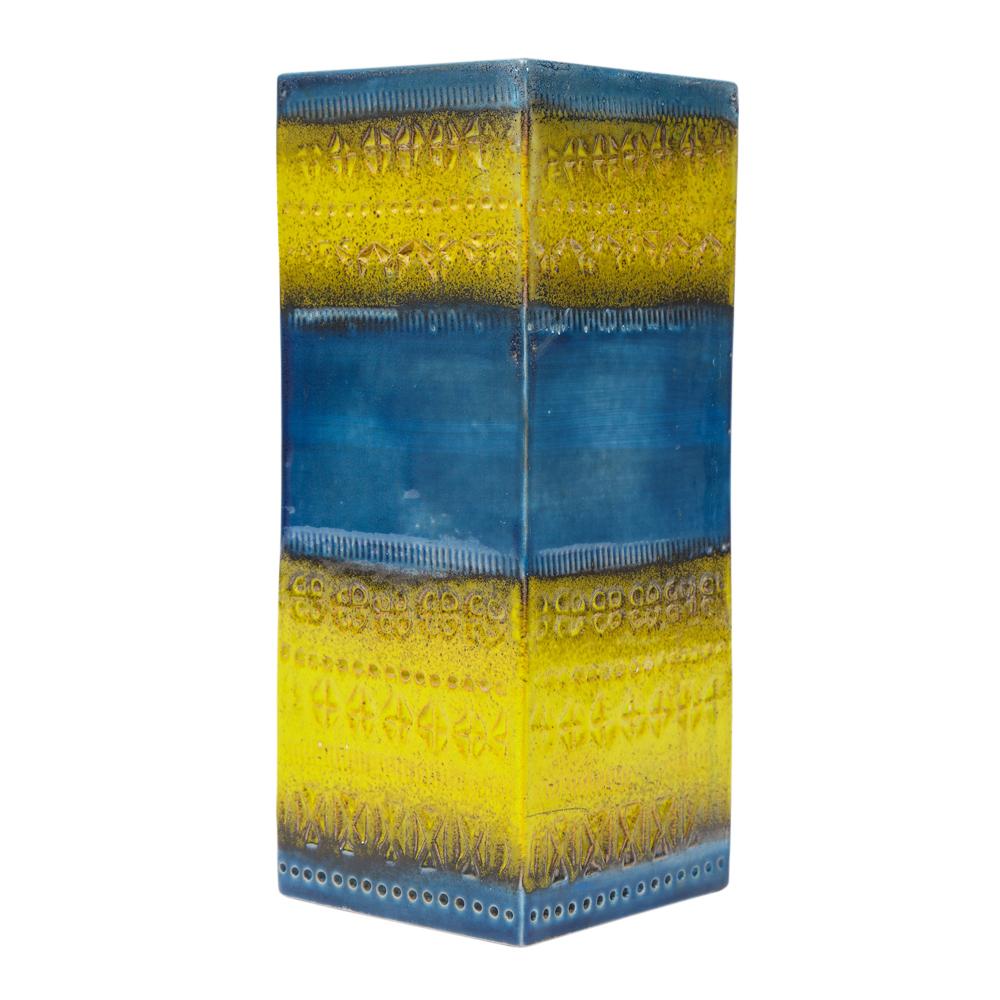 Bitossi vase, ceramic, blue and yellow, signed. Small to medium scale square vase glazed in alternating sections of sapphire blue and yellow. The yellow blocks are decorated with an impressed abstract pattern. The underside is signed with a paper