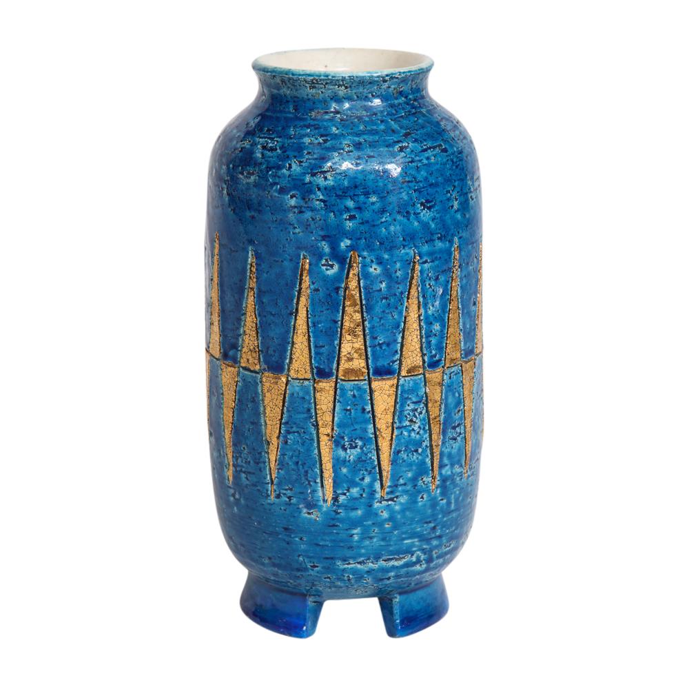 Bitossi Vase, Ceramic, Blue and Gold Geometric, Signed. Medium scale rounded vase with glazed gold diamond pattern over Rimini blue and having footed base. Signed 95/90L Italy on underside of the bowl. Small white mark on one of the feet.
    