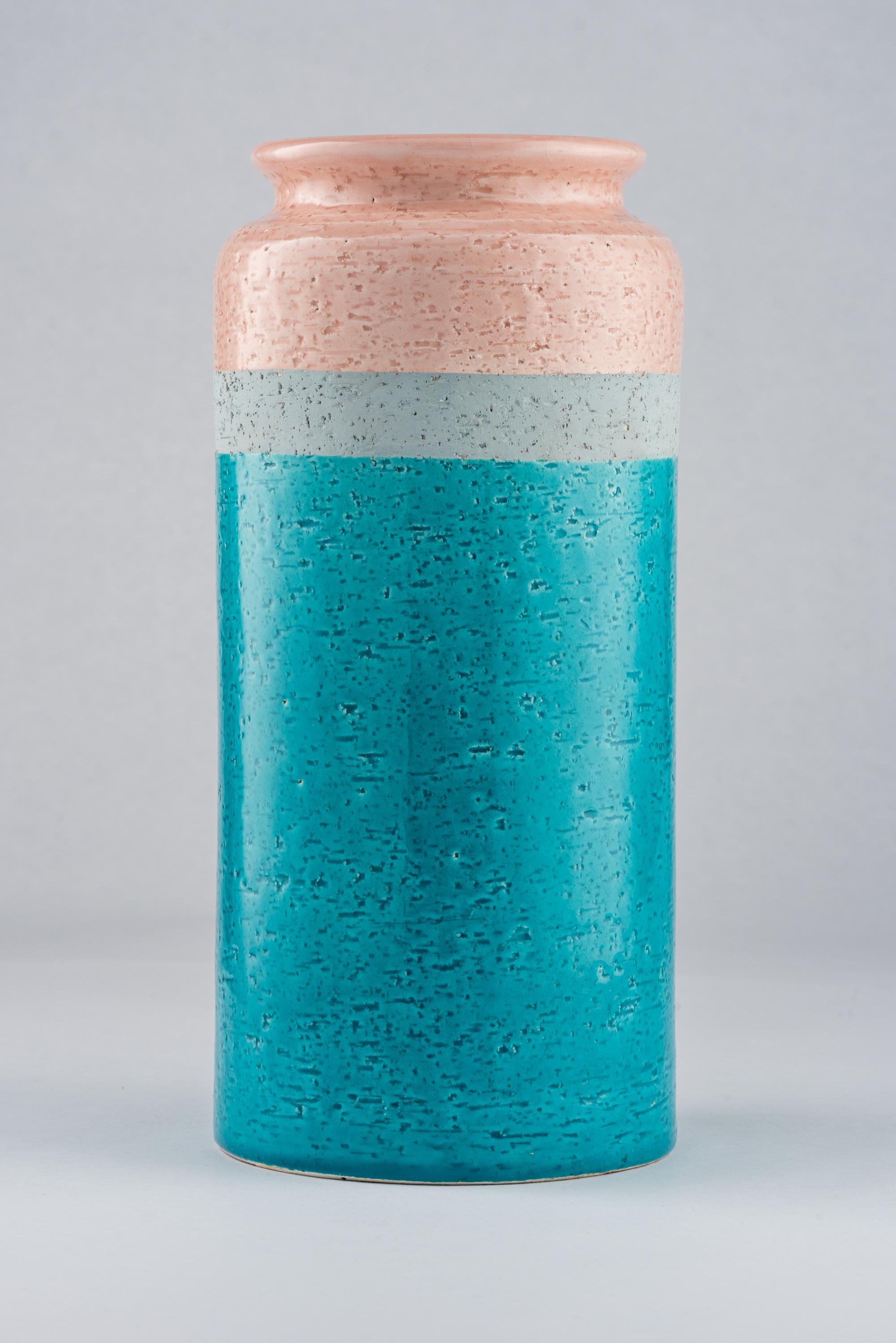 Bitossi vase, ceramic, blue, gray, pink. Tall cylinder vase with a pinched collar and glazed in three bands of color: salmon pink, matte grey, and aqua blue. Remnants of the original paper label on the underside.
  