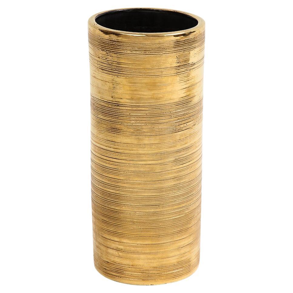 Bitossi vase, ceramic, gold, brushed metallic. Medium scale cylinder vase with a ribbed 24K gold glaze exterior, black interior and an underside in terracotta.
