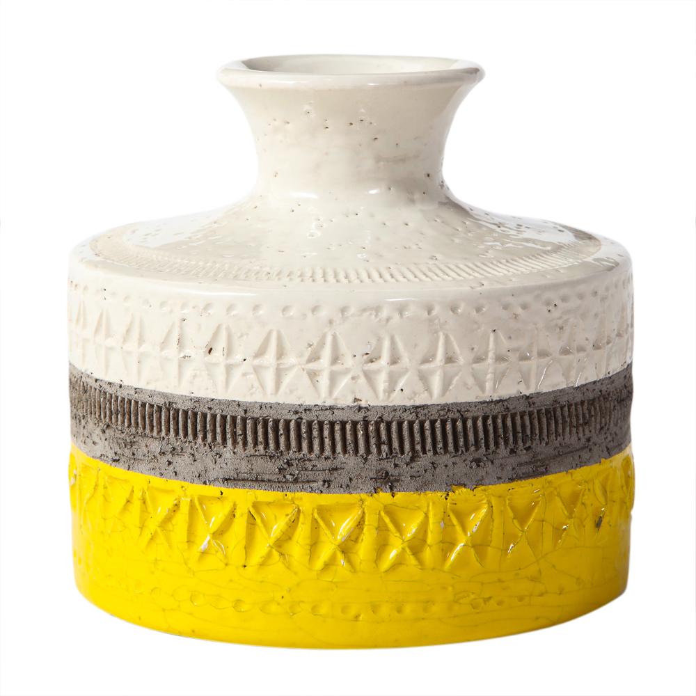 Bitossi vase, ceramic, yellow and white, geometric. Small scale vase decorated with horizontal bands of white, yellow and gray glaze with hand tooled impressed geometric patterns. Glue remnants of an old label visible on the underside.