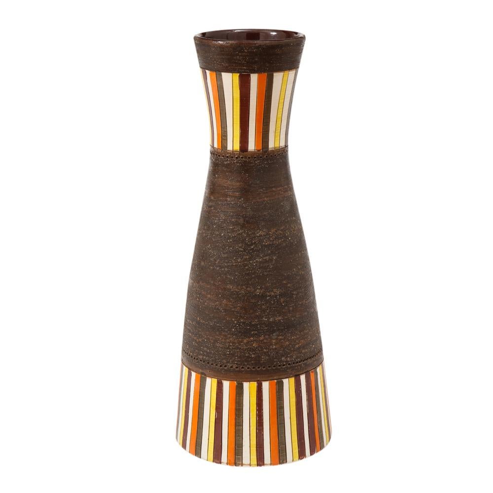 Bitossi vase, large, stripes, matte brown, signed. Tall hourglass form vase decorated with glazed vertical stripes of yellow, white, maroon, orange and brown over a coarse clay body. Signed on the underside 46 A Italy.