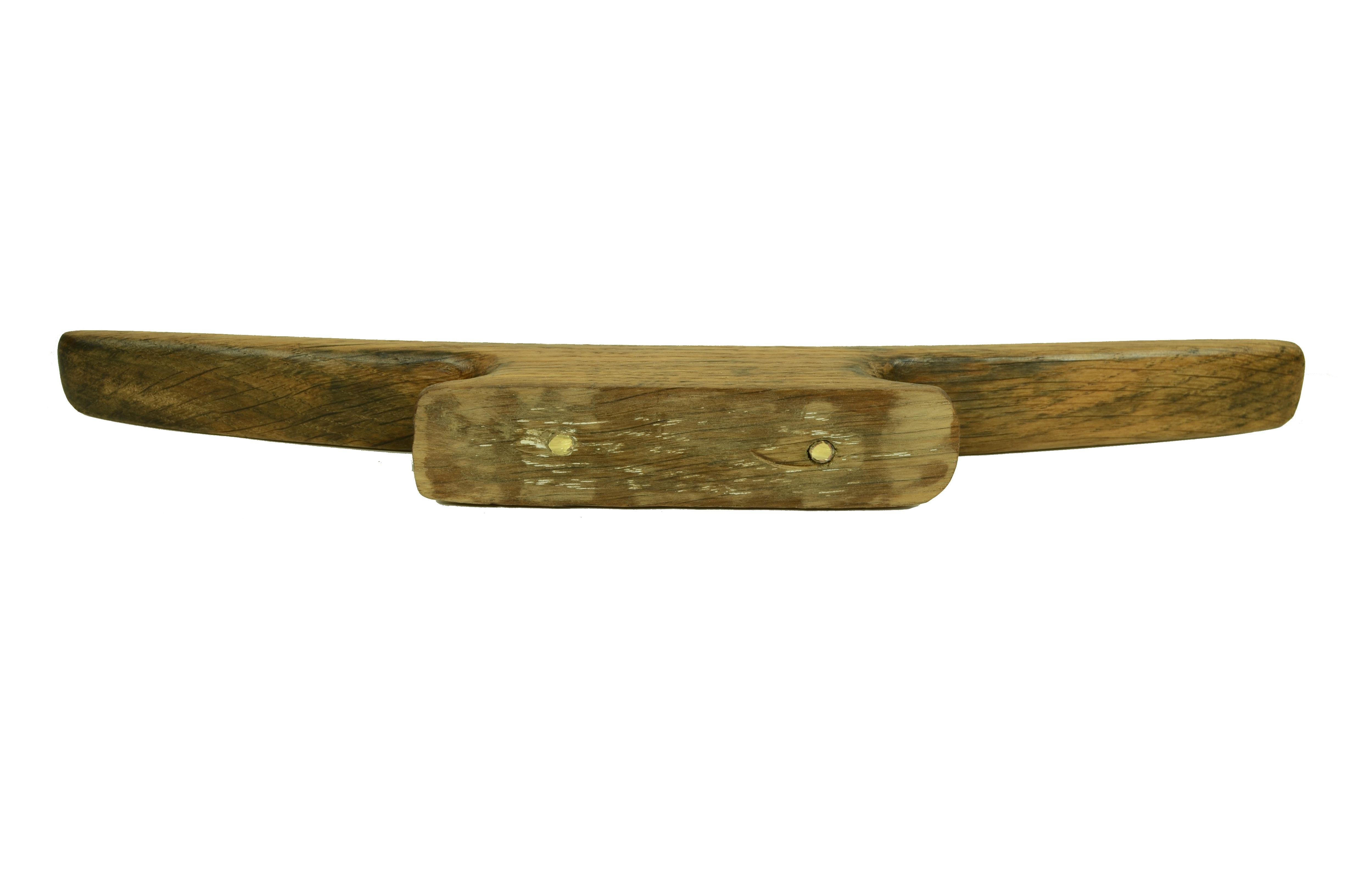 Early 20th century wooden cleat or castanet in the shape of pi used to stop  a line, from a fishing boat in northern France.  Generally  secured by strong through-bolting screws on a strong part of the deck hull. 
Good condition. Measurements