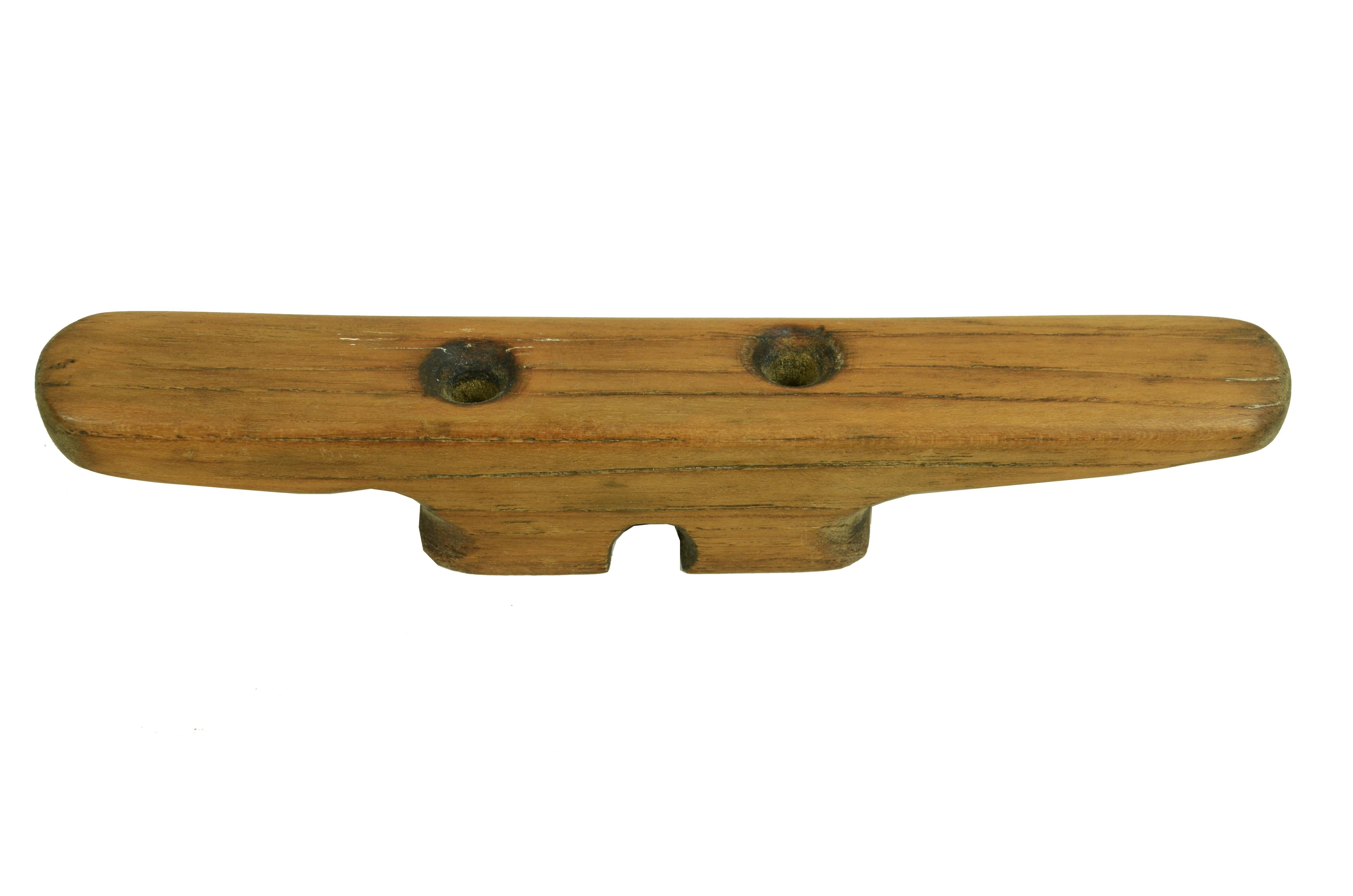 Early 20th century mahogany wood cleat or castanet in the shape of pi used to stop  a line, from a fishing boat in northern France.  Generally  secured by strong through-bolting screws on a strong part of the deck hull. 
Measurements 20.5x3.5x3.5 -