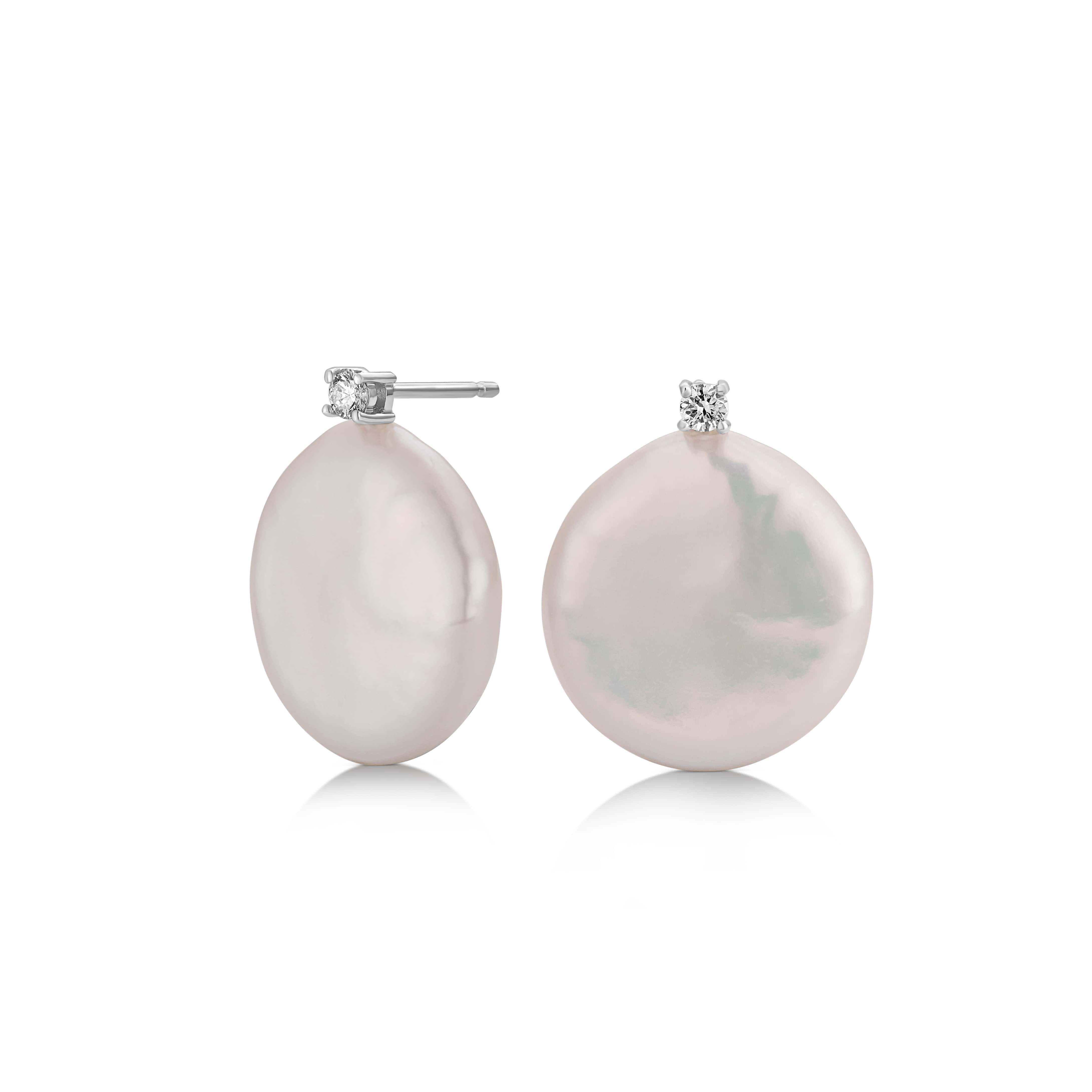 These 18K white gold earrings from the Biwa Collection present a fusion of nature’s splendor and refined craftsmanship. Each earring features a beautifully unique 13 by 15 mm white Fresh Water Keshi pearl, crowned with a brilliant 0.06 ct diamond