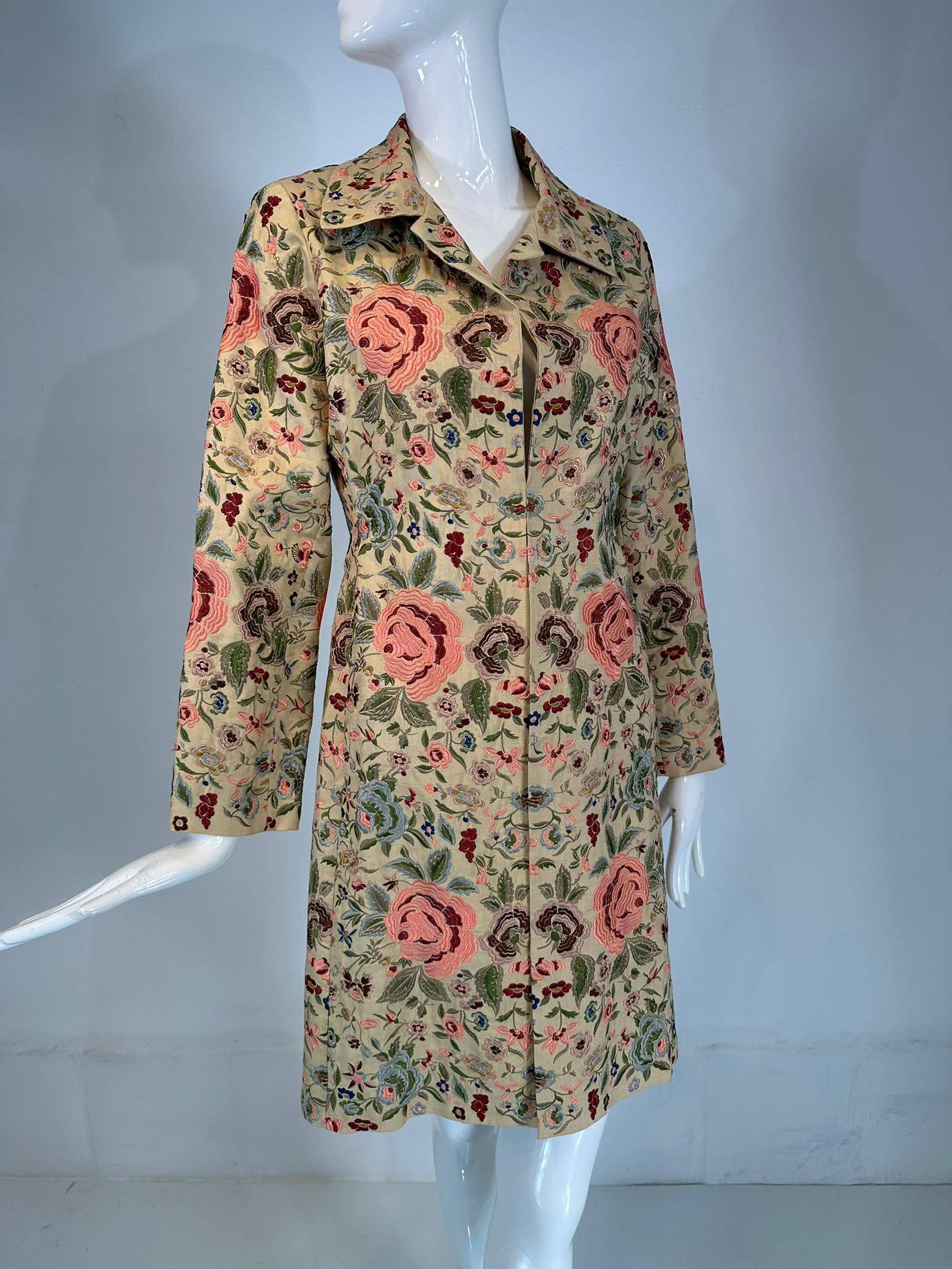 Biya heavily embroidered off white silk coat. A beautiful coat heavily embroidered with large and small roses in pink and burgundy  with foliage twining throughout in pale greens & blues. Open front coat, there are hook & eyes at the approximate