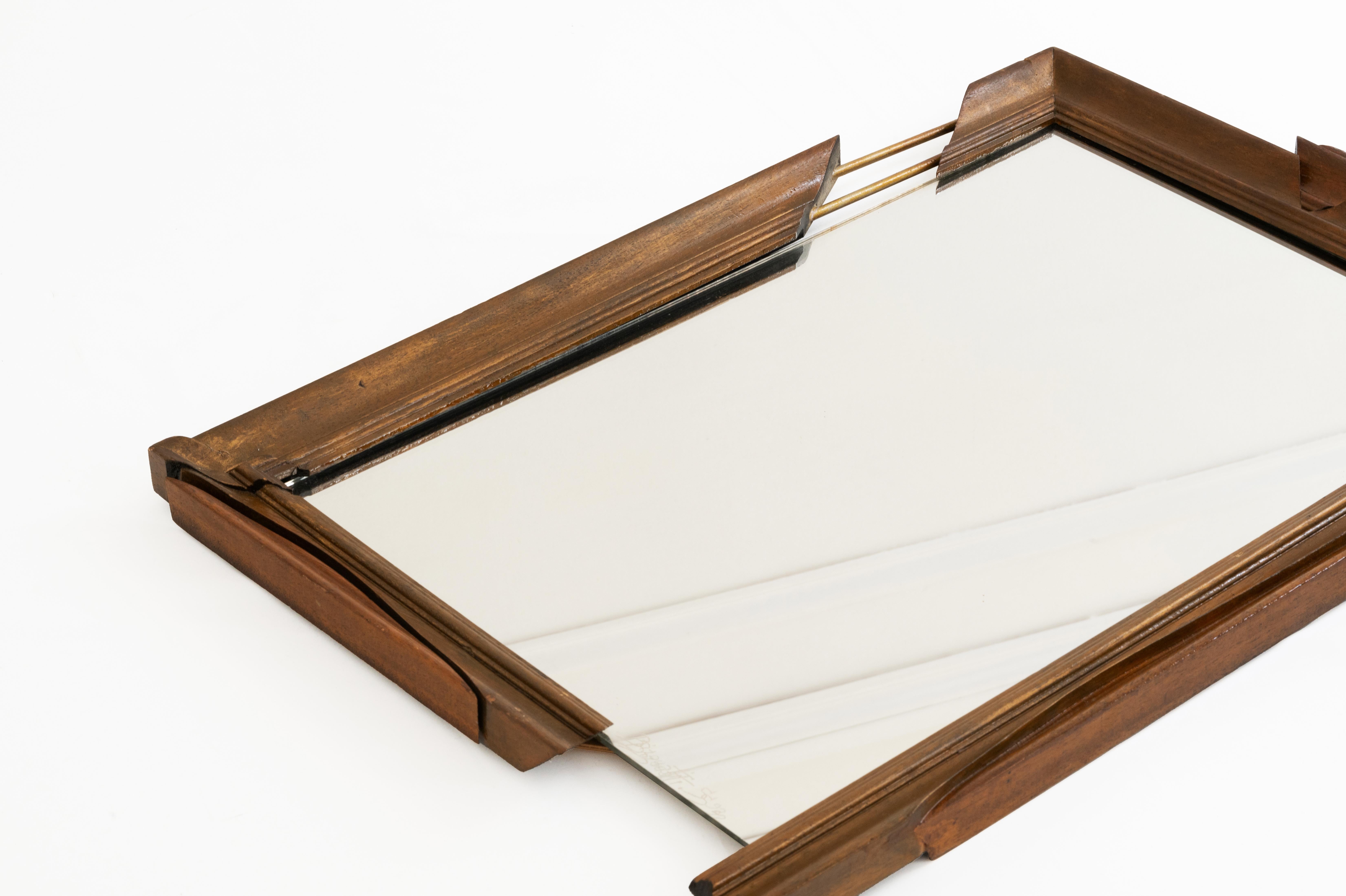 
This incredible asymmetrical mirror in hand-carved wood signed by « Bizouati » and dated 1992 is a unique and artistic piece that blends craftsmanship with abstract design. The frame and the metal rod showcase intricate handmade details,