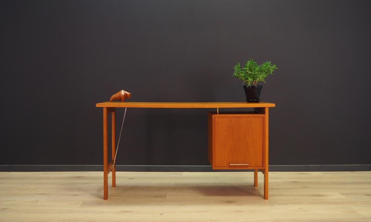 Writing desk from the 1960s-1970s, minimalistic Danish design, perfect in every detail. The desk was produced at Bjerringbro Mobelfabrik. Furniture veneered with teak, original handles. It has a roomy box, inside which there are drawers, the largest
