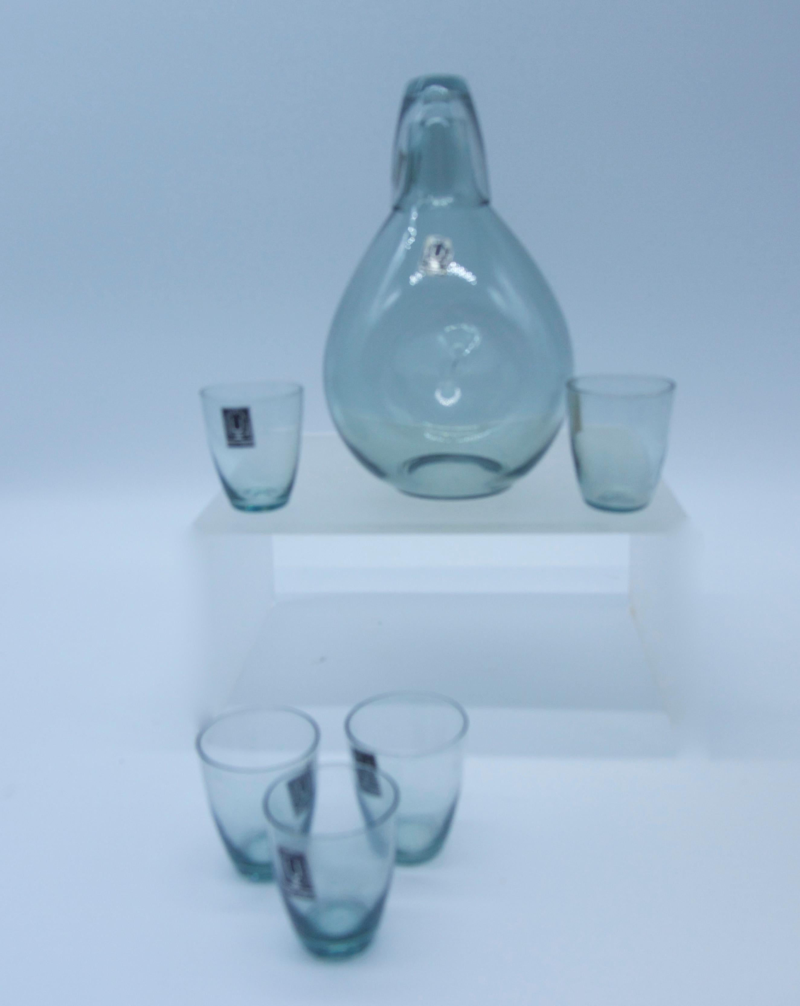 Bjorkshult Wuidart (Swedish) smoked grey glass decanter and shot glasses

The delicate carafe is H 19cm with pinched or dimpled side with polished pontile and label


The 6 x glasses (one inverted serves as stopper as per photograph) H 5cms