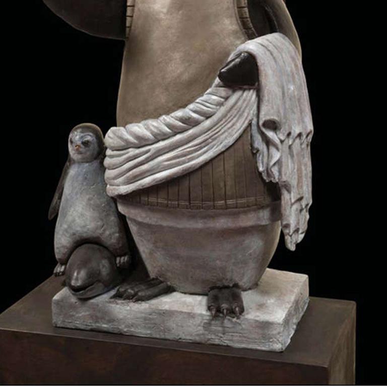 Bronze sculpture of an emperor penguin dressed in an emperor's military parade garb.