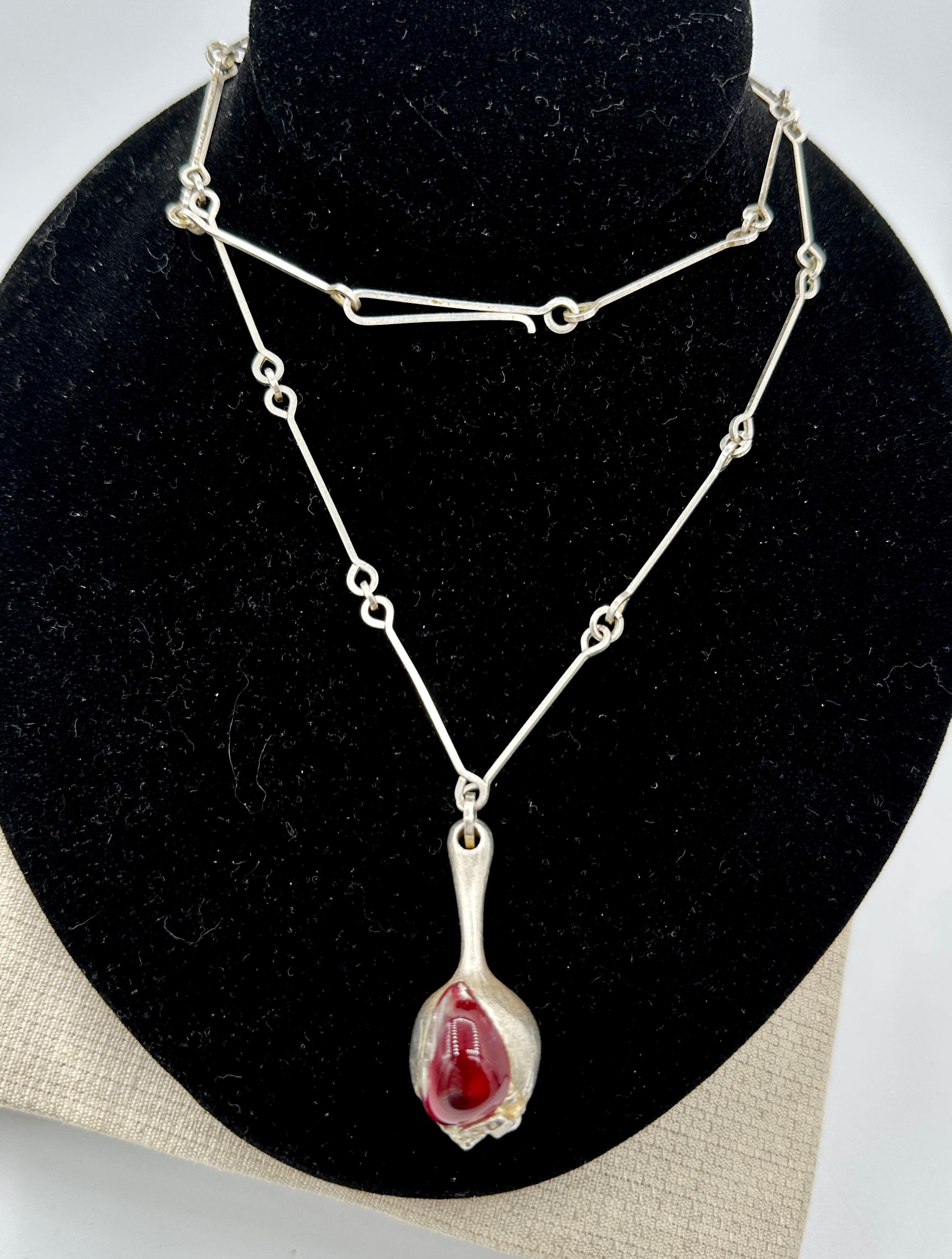 This is the rare Modernist Nectaris Necklace by Finnish jewelry designer Björn Weckström for Lapponia in Red Acrylic Crystal and Sterling Silver.  The classic Mid Century brutalist piece was designed in the 1970s for Lapponia Jewelry in Finland.  An