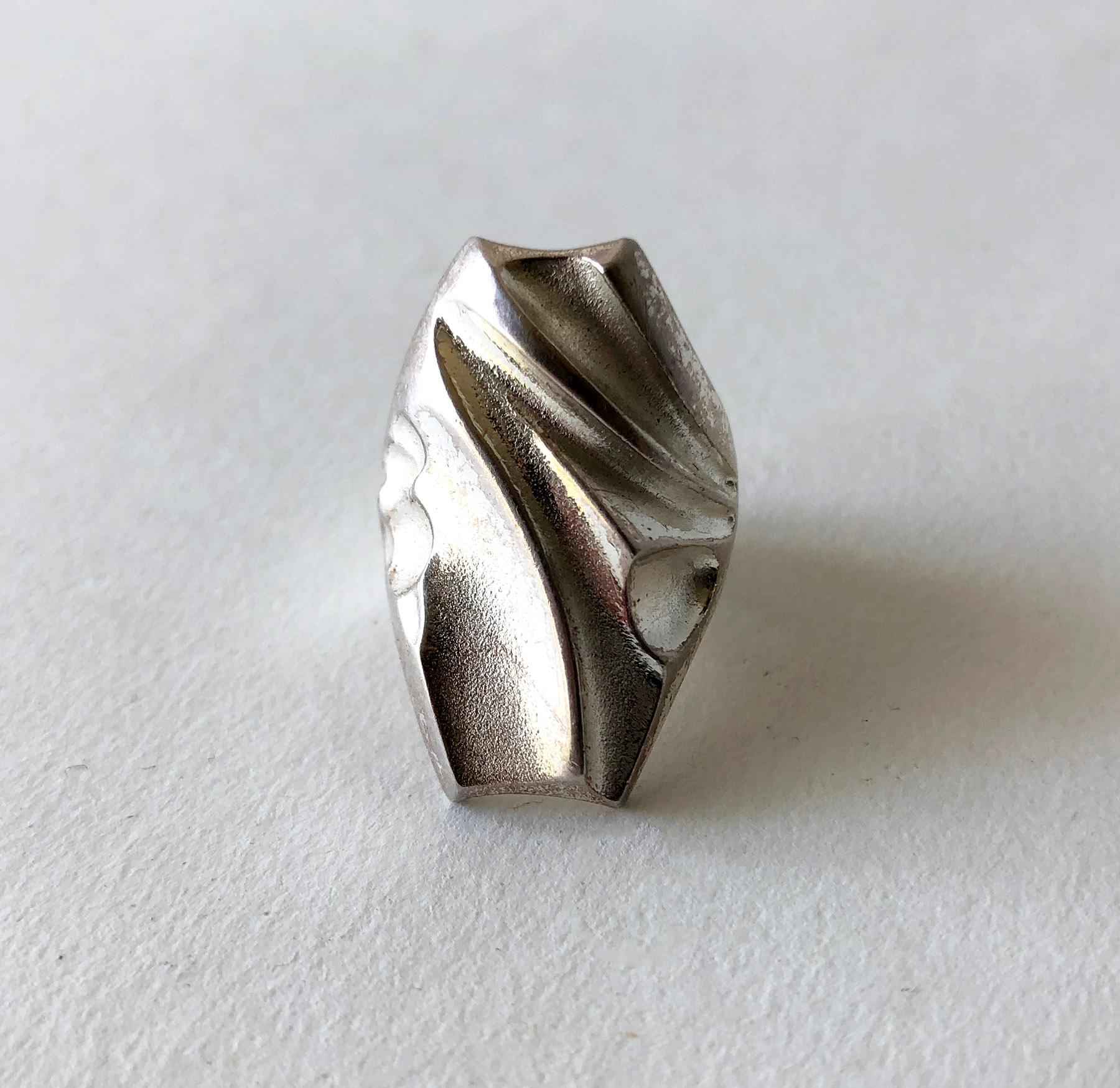 Sterling silver ring created by master sculptor and jeweler Bjorn Weckstrom of Finland.  Ring is a finger size 6.5 and is signed 925, X8 (1999), Lapponia.  In very good vintage condition.  