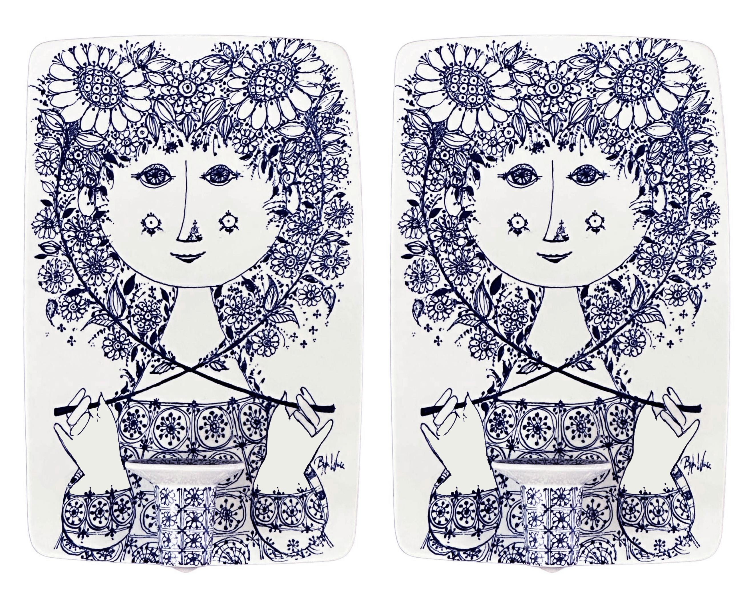 A pair of porcelain candleholder wall sconces by Bjorn Wiinblad for Nymolle. 

Denmark 1960s. 

Blue hand-painted decoration. Artist signed on the face, signed and numbered in verso. 