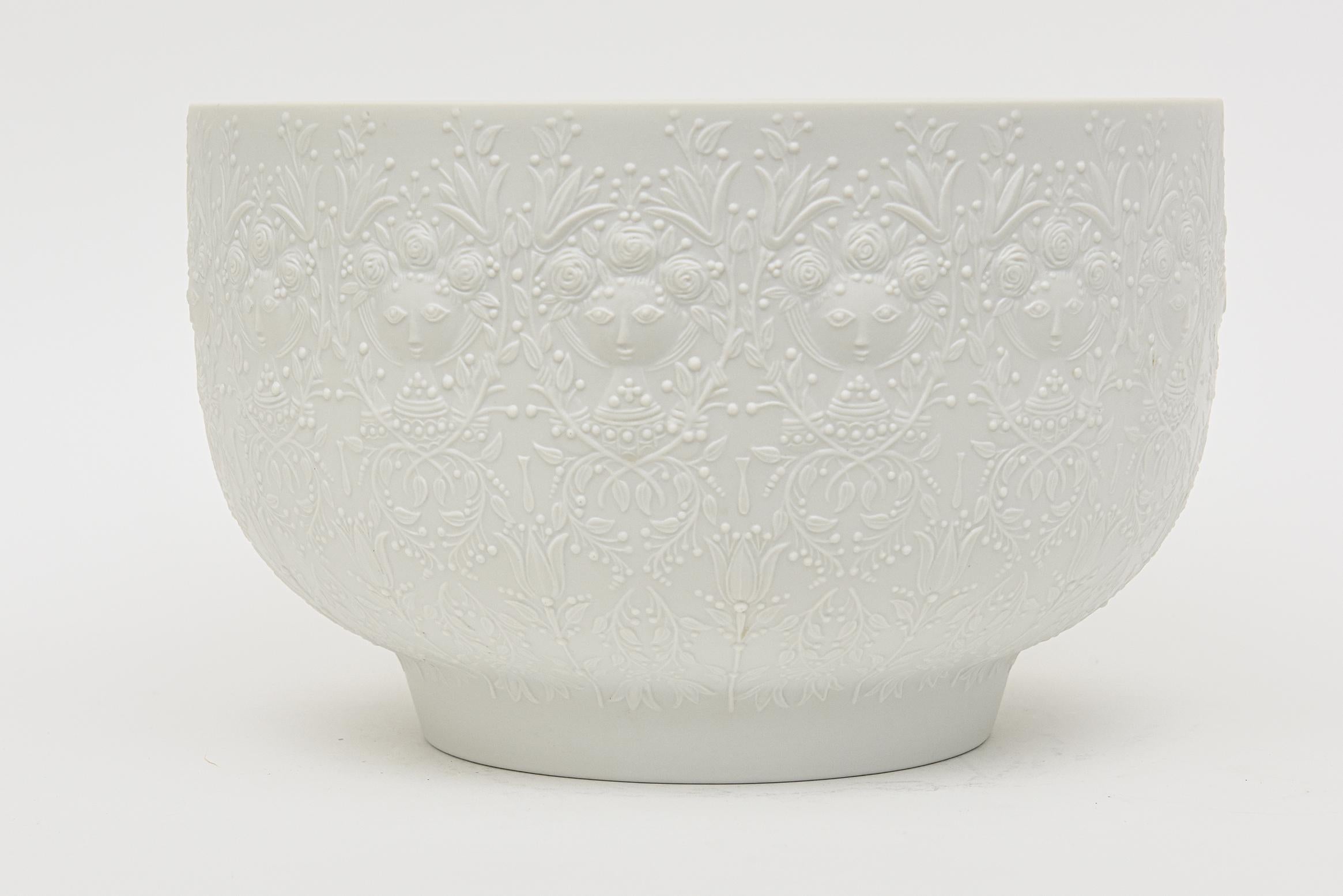 This fabulous monumental vintage hallmarked porcelain white mat bisque bowl was designed by Bjorn Wiinblad for Rosenthal Studio LInie from Germany. It is textural and has raised faces surround that Bjorn Wiinblad was so known for. This is rare