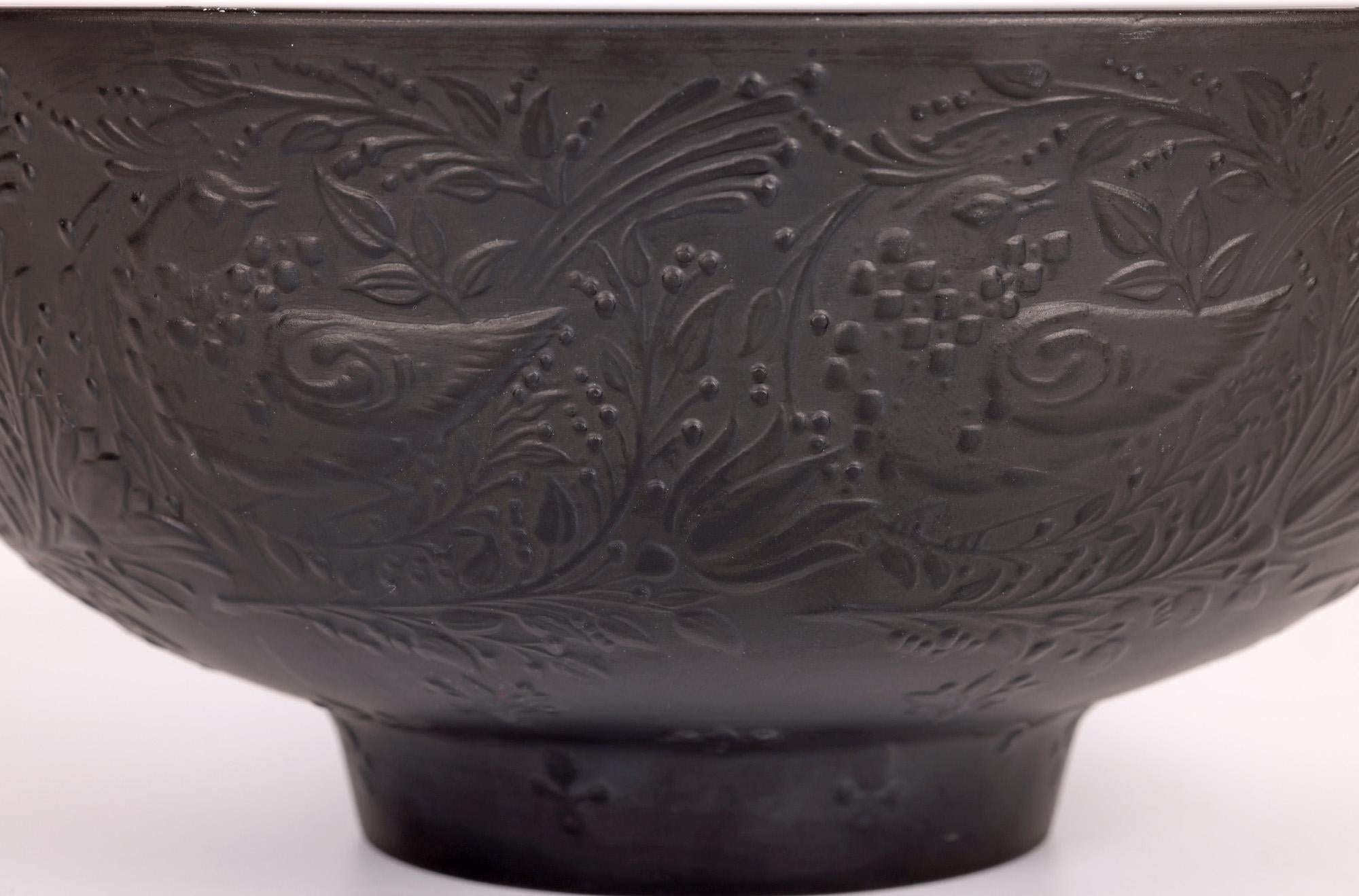 A finely made and stylish mid-century large Rosenthal porcelain bowl decorated with birds amidst foliage designed by renowned Danish born artist Bjorn Wiinblad (1918-2006). The bowl stands raised on a narrow round foot and is made in black with a