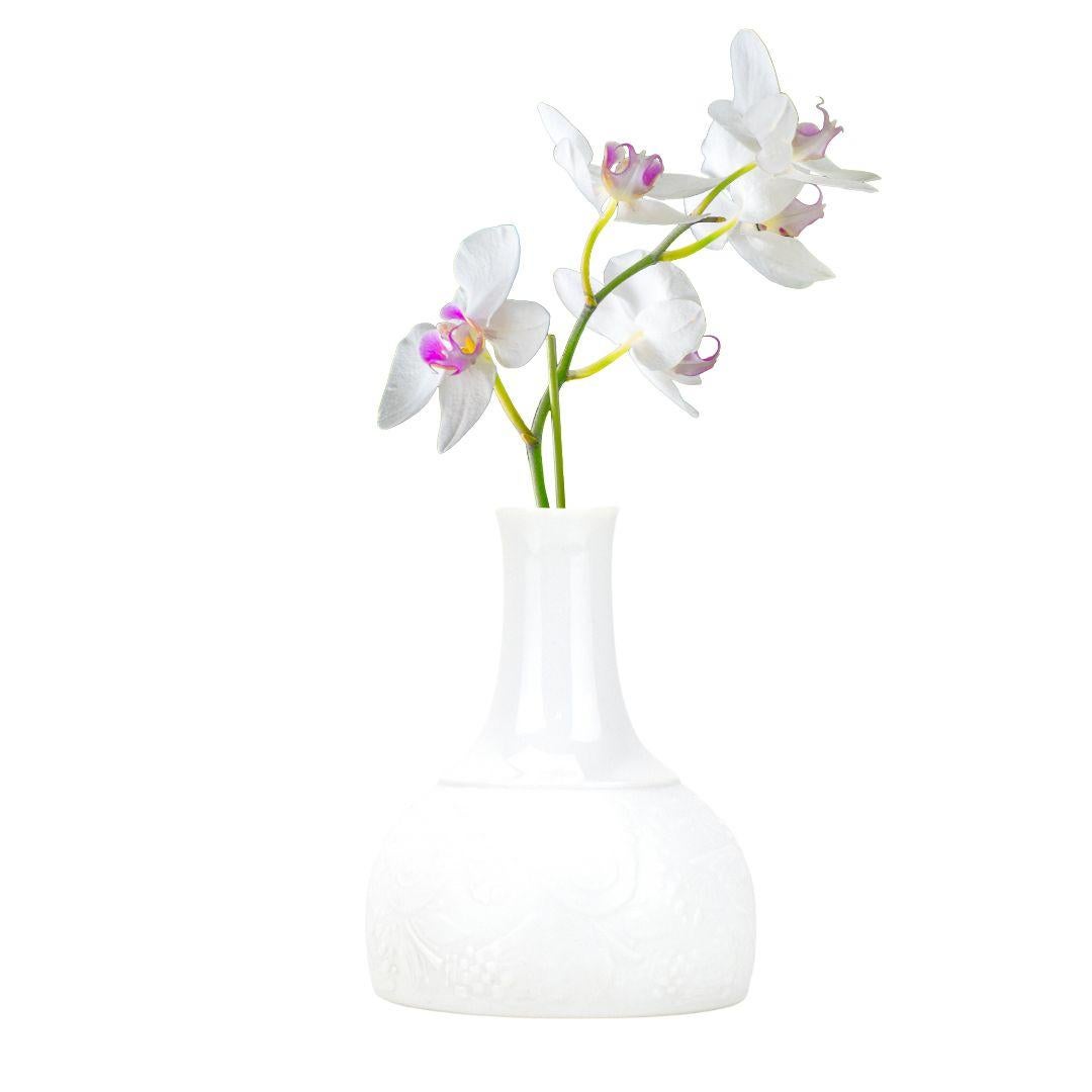 This Rosenthal studio-line vase is a stunning piece of design that combines matte unglazed and glossy glazed finishes to create a truly unique look. 
The matte area of the vase is decorated with a relief pattern of doves, which adds a touch of