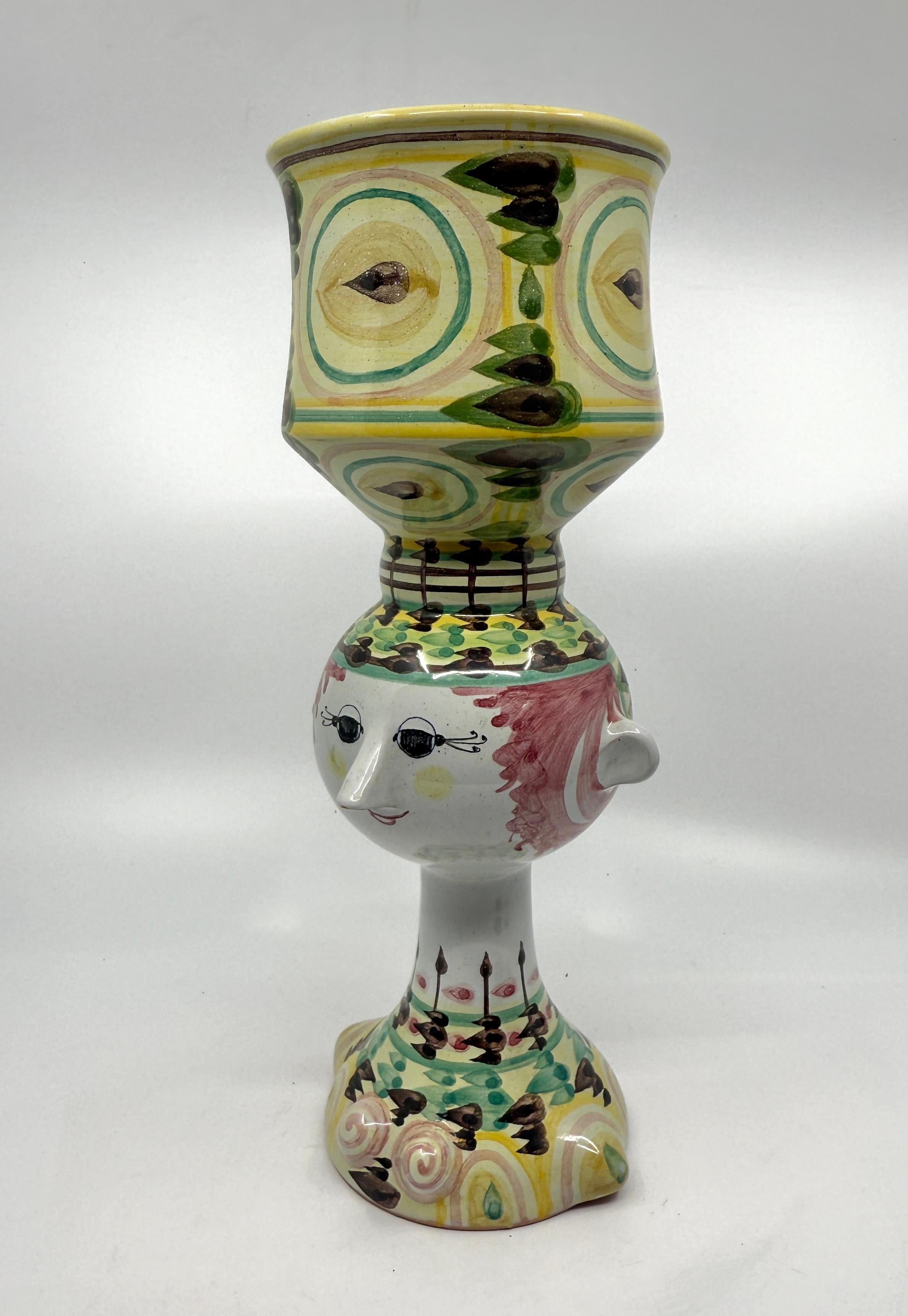 A cute whimsical piece of pottery by the Danish master Bjorn Winblad. It is signed on the base and marked Danmark. Approximately 12 inches tall the piece is beautifully decorated and painted. The piece is in good condition although there is a glaze