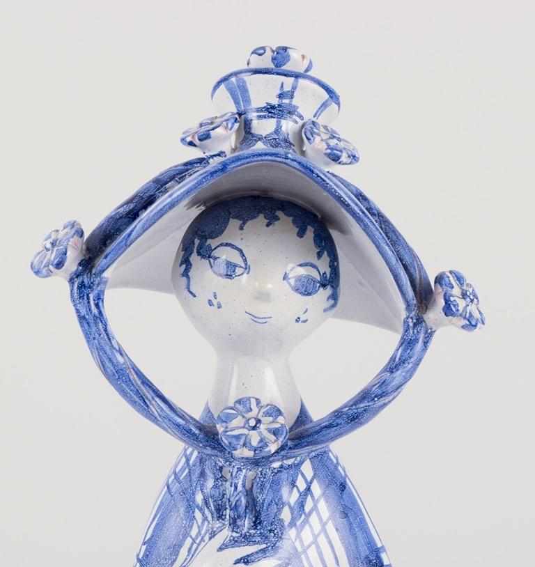 Pre-owned goods are exempt from import duties for U.S. customers. 
Therefore, no import tariffs will be applicable to your purchase.

Bjørn Wiinblad (1918-2006). 
“Autumn” from the series ‘The Four Seasons’, figure in blue glazed earthenware. 
Model