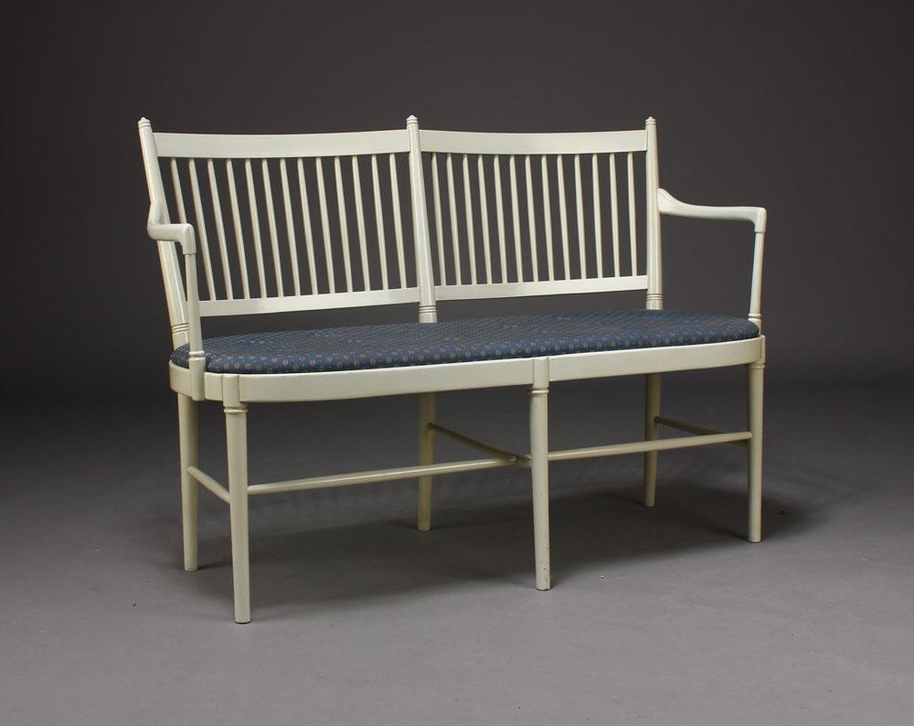 In 1967 Bjørn Wiinblad and Brita Drewsen together designed a series of wooden Gustavian style furniture. Two-seat. Bench of lacquered wood with lumber back, seat upholstered with patterned fabric, tapered legs, 1960s-1970s. L. 116 cm. Made by Nessjö
