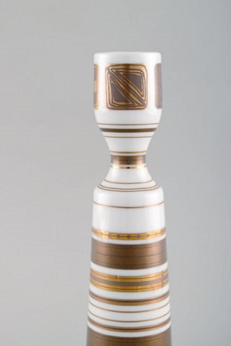 Bjørn Wiinblad candlestick made of porcelain, decorated in gold, 1980s.
In perfect condition.
Measures: 21.5 x 5.2 cm.
Stamped.