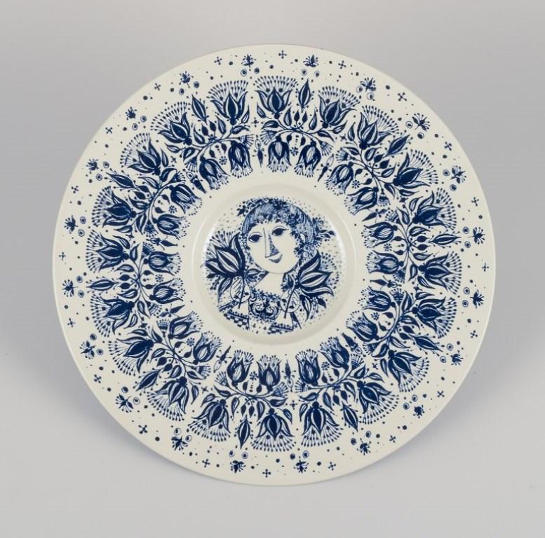 Bjørn Wiinblad (1918-2006) for Nymølle, Denmark. 
Two large faience dishes with classic Wiinblad motifs in blue and brown.
From the 1970s.
Marked.
In perfect condition.
Small dish: Diameter 26.0 cm x Height 2.5 cm.
Large dish: Diameter 30.5 cm x