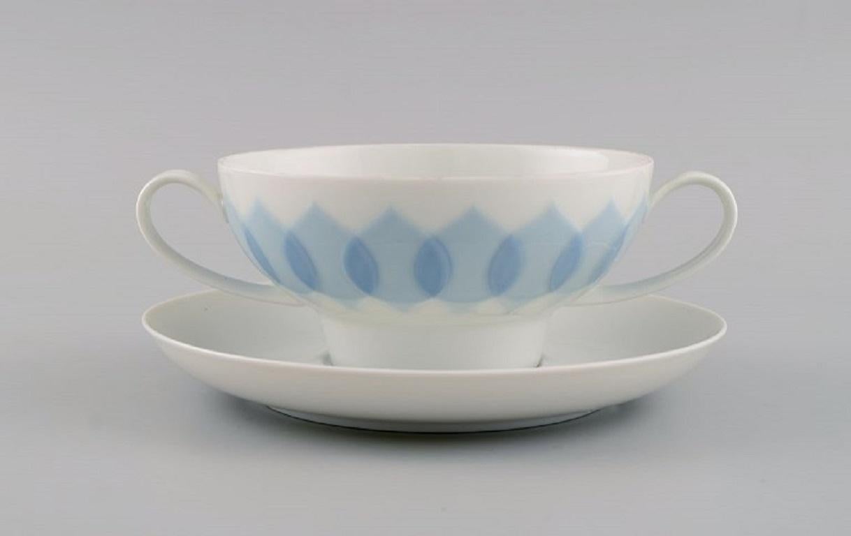 Bjørn Wiinblad for Rosenthal. 
Twelve Lotus porcelain bouillon cups with saucers decorated with light blue lotus leaves. 1980s.
The cup measures: 12.2 x 6 cm.
Saucer diameter: 16.5 cm.
In excellent condition.
Stamped.