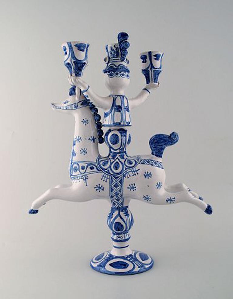 Bjørn Wiinblad large ceramic figure from the blue house.
Figure / candlestick, rider on horseback with space for three lights.
Decoration number L5.
Dated 1972.
Measures: 40 cm x 30 cm.
Perfect condition.