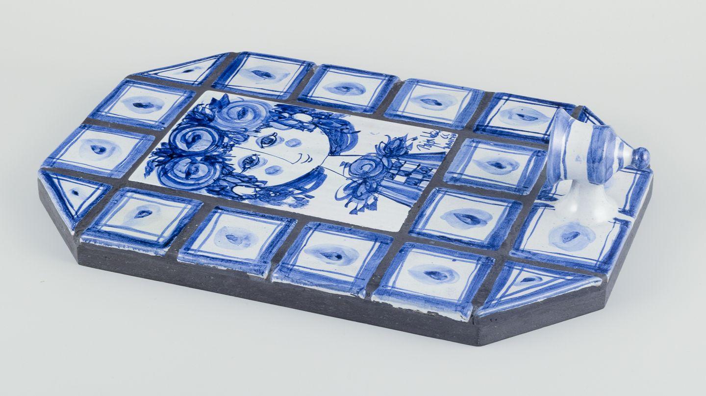 Pre-owned goods are exempt from import duties for U.S. customers. 
Therefore, no import tariffs will be applicable to your purchase.

Bjørn Wiinblad (1918-2006), Det Blå Hus (The Blue House), own studio.
Candlelight holder on tiles - hand-glazed