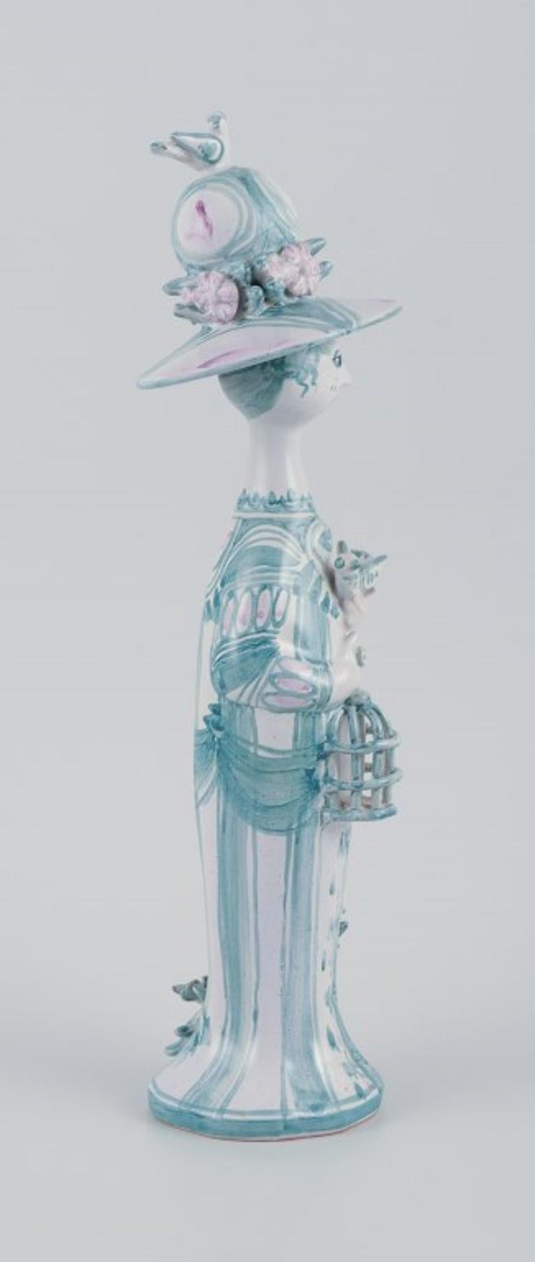 PRE-OWNED GOODS ARE EXEMPT FROM IMPORT TARIFFS FOR U.S., UK, AUSTRALIAN & CANADIAN CUSTOMERS.   
THEREFORE, NO IMPORT TARIFFS WILL BE APPLICABLE TO YOUR PURCHASE. 

Bjørn Wiinblad (1918-2006), a unique ceramic figure.
‘Spring’ in green from ‘The