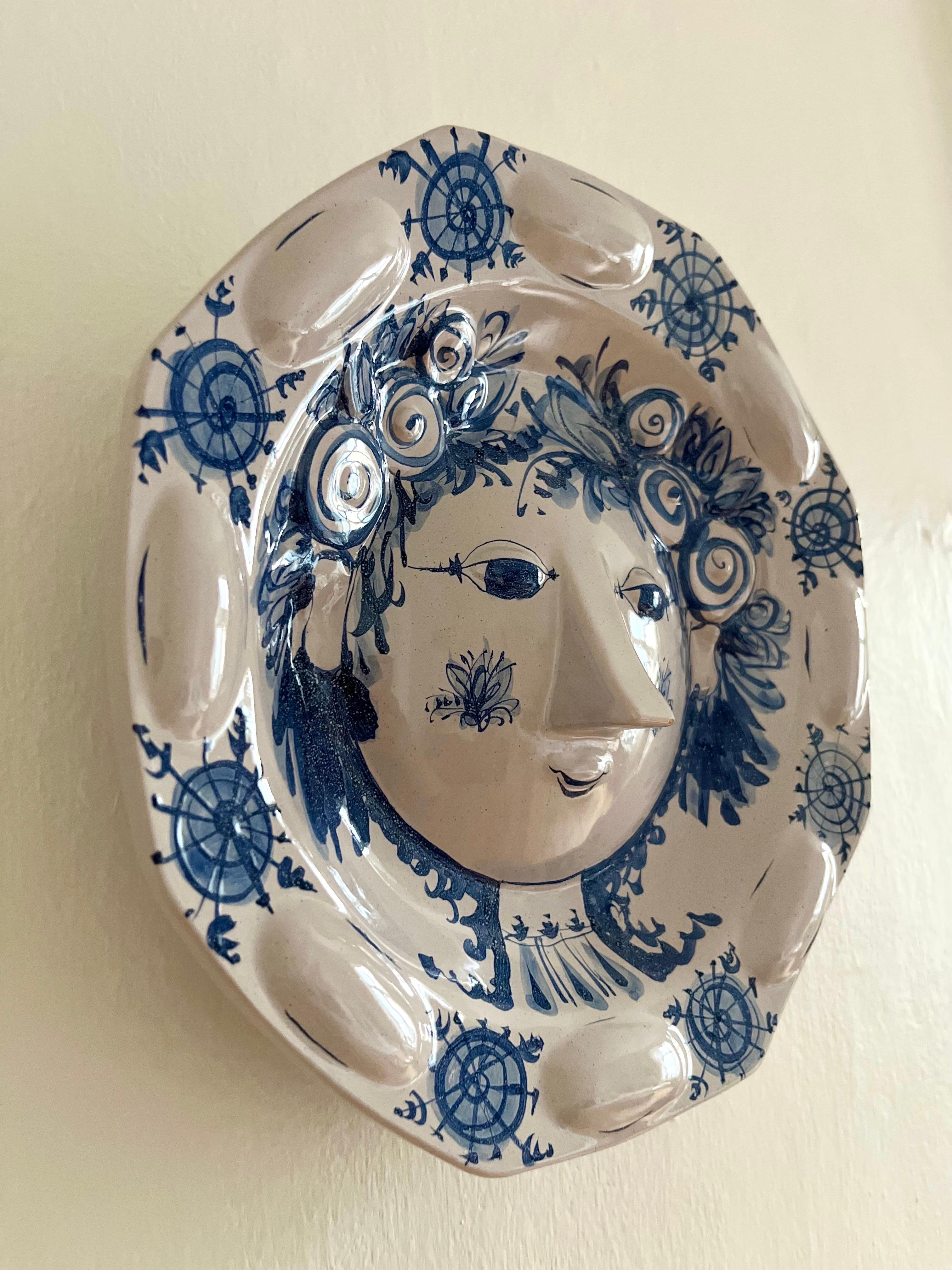 Unique handmade and hand-painted wall decoration / plate by Danish artist Bjørn Wiinblad from 1975. Depicts a woman's face in glazed ceramic, white and blue. Very decorative, this piece is hand sculpted in a reliefic style in Wiinblad's studio,