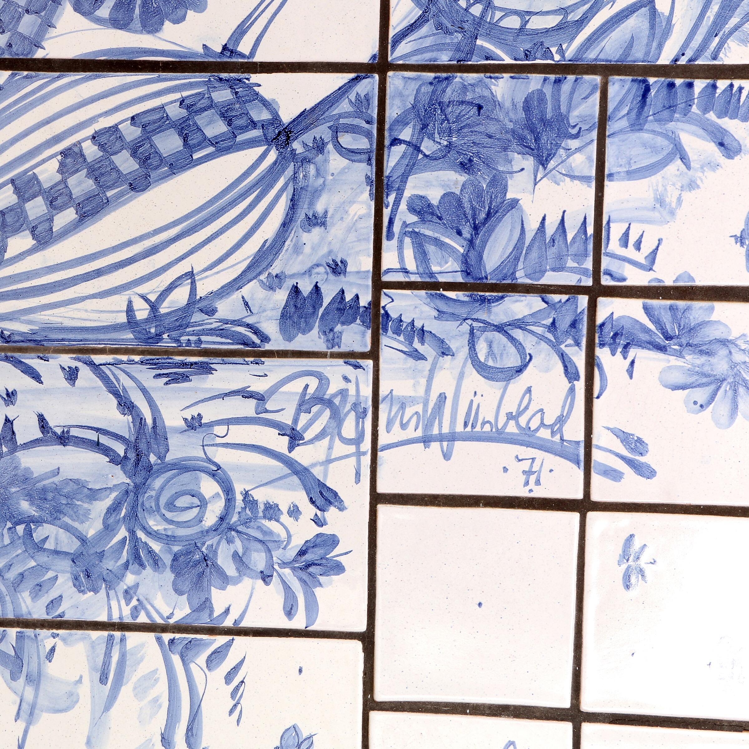 Bjørn Wiinblad, very large rectangular relief with blue glazed tiles depicting a tree and two figures. Signed Bjørn Wiinblad 71. Measures: H. 302 cm., B. 105 cm. Earthenware tiles decorated with blue glazed motifs on a light grey base. Unique.