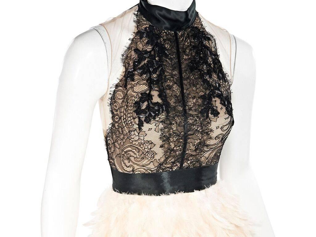 Product details:  Black Chantilly lace cocktail dress by Marchesa.  Halterneck ties at back.  Sleeveless.  Banded waist.  Concealed back zip closure.  Blush feathered skirting.  30