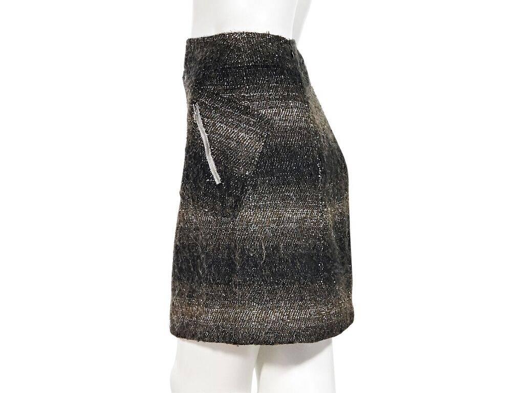 Product details:  Black and brown wool mini skirt by Chanel.  Waist zip pockets.  Concealed back zip closure.  28