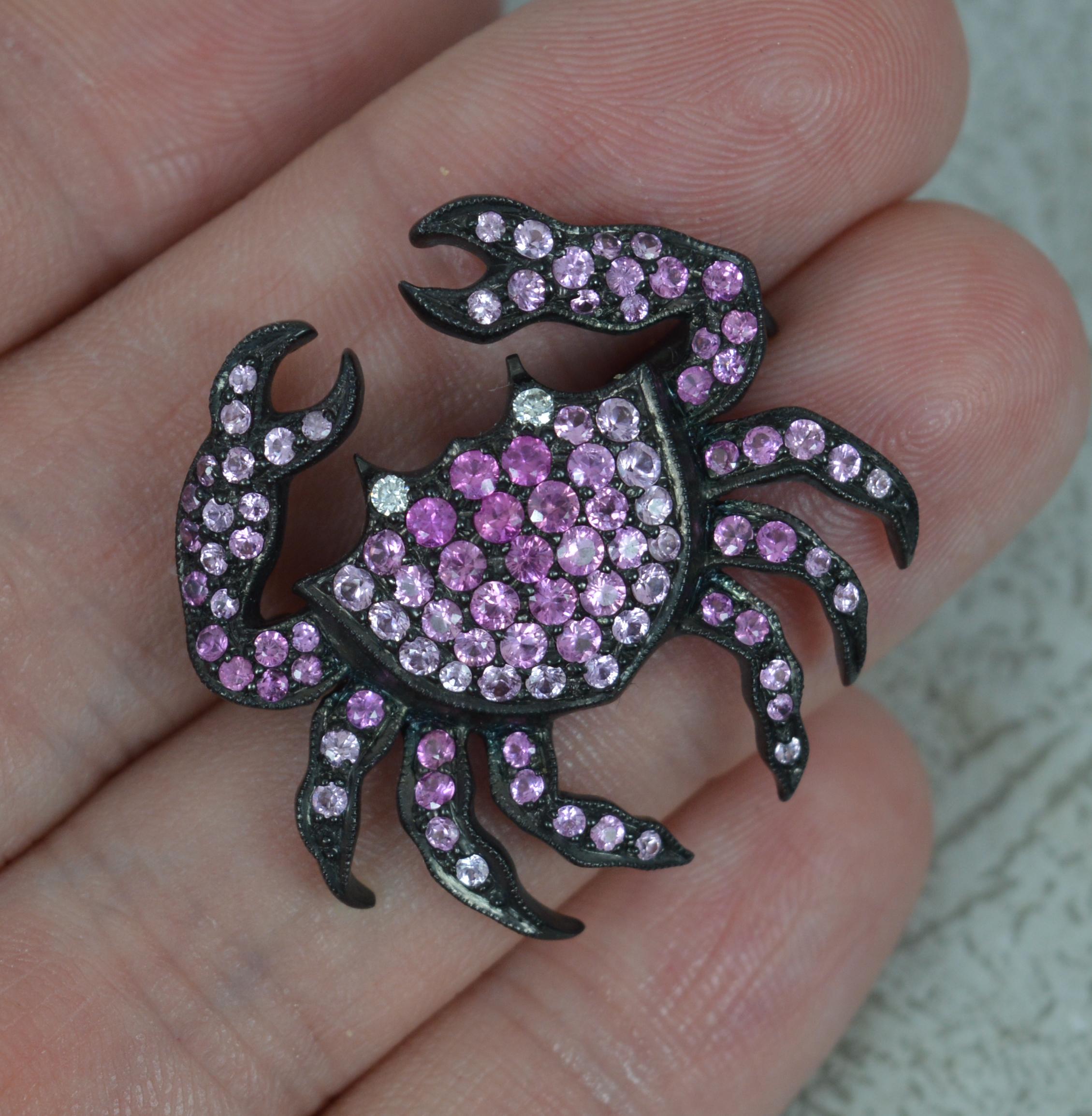 A superb quality and highly unusual crab pendant brooch.
Solid 18 carat white gold which has been expertly oxidized all over to give a blackened matt finish.
The crab set with a round brilliant cut diamond to each eye. The body, legs and claws then