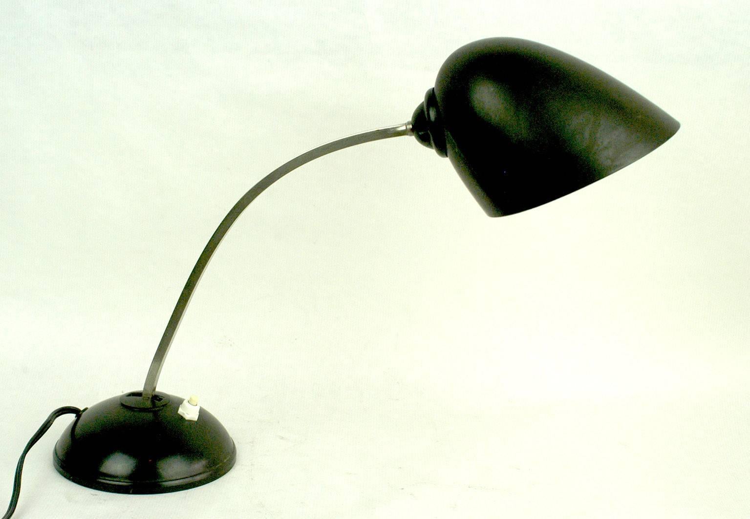 Charming Bauhaus or Industrial style black desk lamp from the 1930s with adjustable shade and chrome stem, which can be adjusted as well. It’s shape is very close to E.K. Coles desk lamps and it has a manufacturers mark on the underside. After years