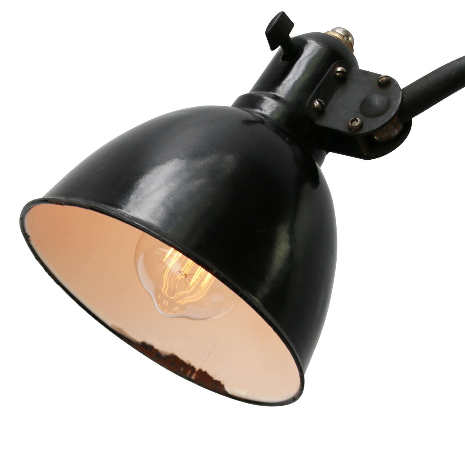 Black enamel industrial 2 arm work light by Peter Behrens for AEG, circa 1920s
adjustable in height and angle
including plug and switch

Weight: 2.40 kg / 5.3 lb

Priced per individual item. All lamps have been made suitable by international