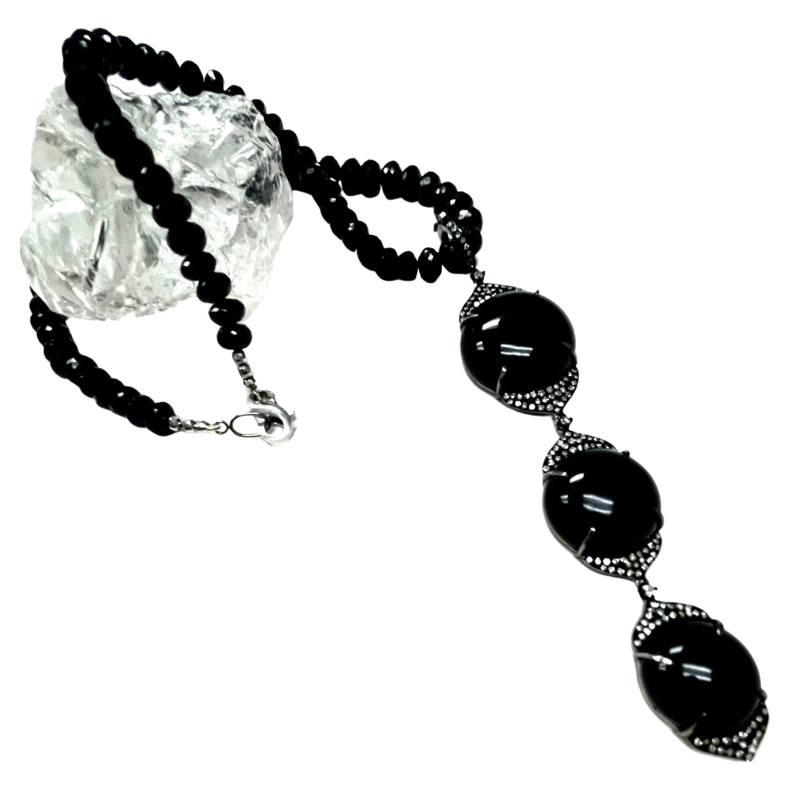Description
Elegant onyx cabochons with pave diamonds suspended from a beautiful faceted black spinel necklace.
Item # N3821

Materials and Weight
Onyx 64cts, 23, 20, and 17mm, cabochon round shape
Pave diamonds 1.42cts.
Faceted balls 3mm 14k white