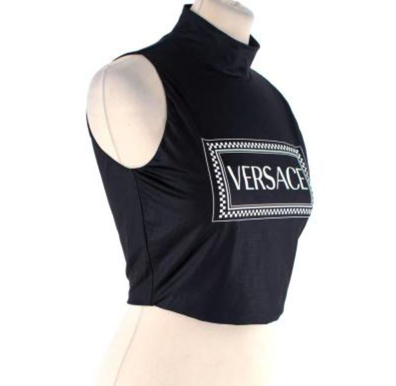 Versace Black 90s Vintage Logo Print Crop Top
 

 - White box logo on center front 
 - Crop length with high neckline 
 - Full zipper in back 
 - Stretchy and soft feel 
 

 Materials 
 89% Polyamide 
 11% Elastane 
 

 Made in Italy
 9.5/10