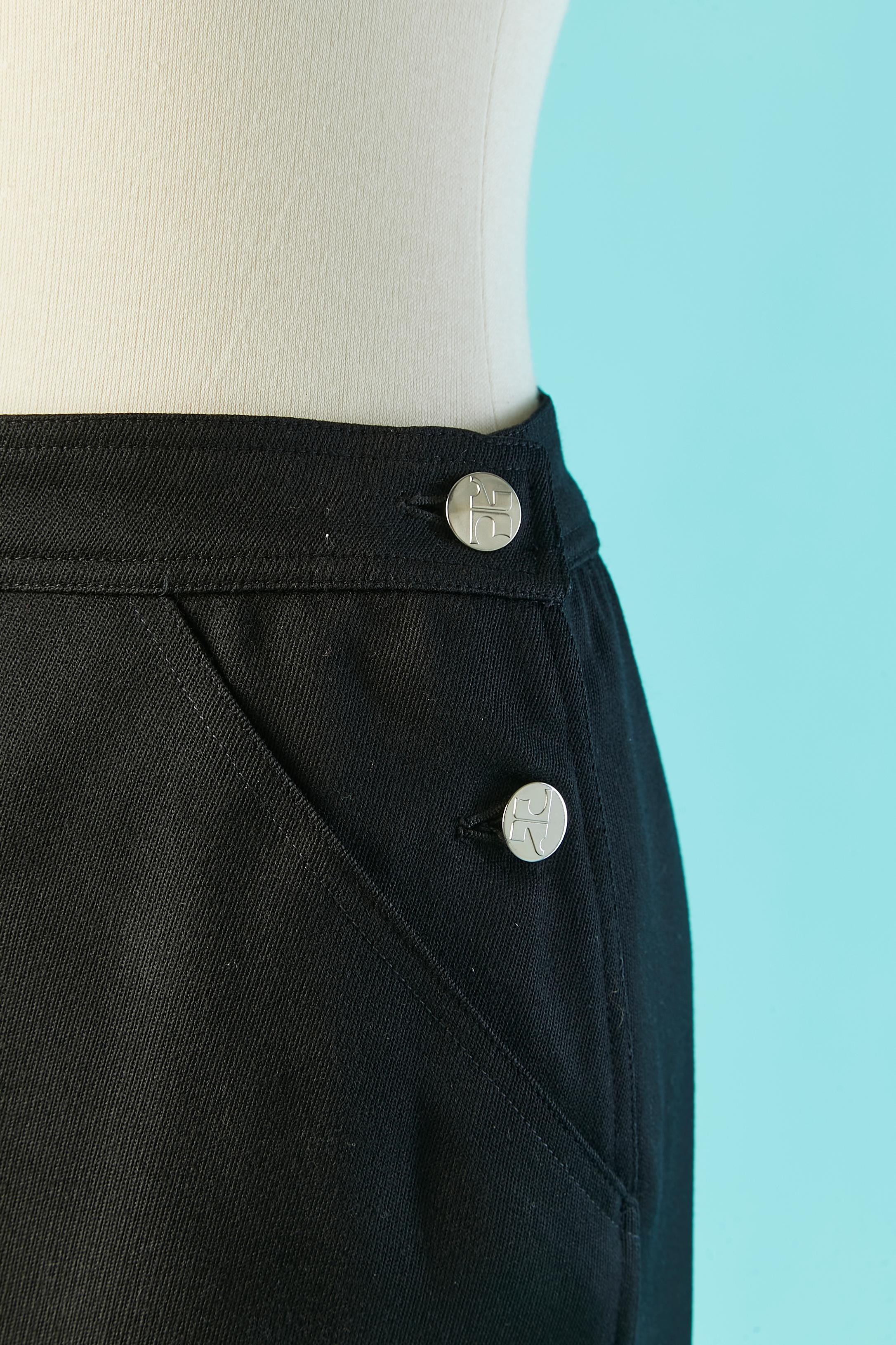 Black A-line skirt with branded button. Main fabric composition : wool & polyester. Acetate lining. Pocket and split on both side, lenght = 15 cm 
SIZE 38 (Fr) M 