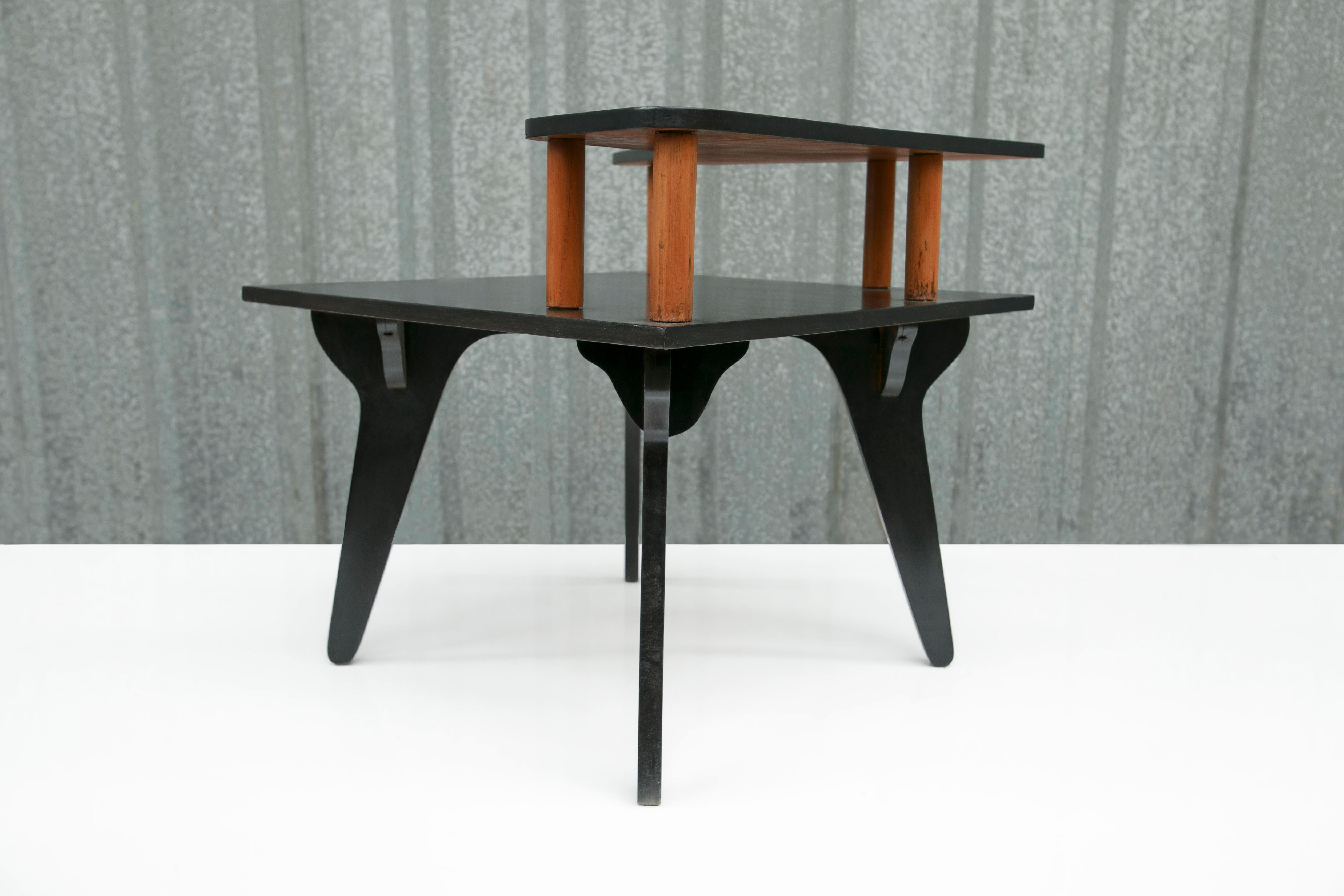 Available right now, this Mid Century Modern accent/phone table in plywood designed by Jose Zanine Caldas in the fifties is beautiful! The table consists of four legs and two shelves painted in black. Zanine’s manufacturing seal is under the table